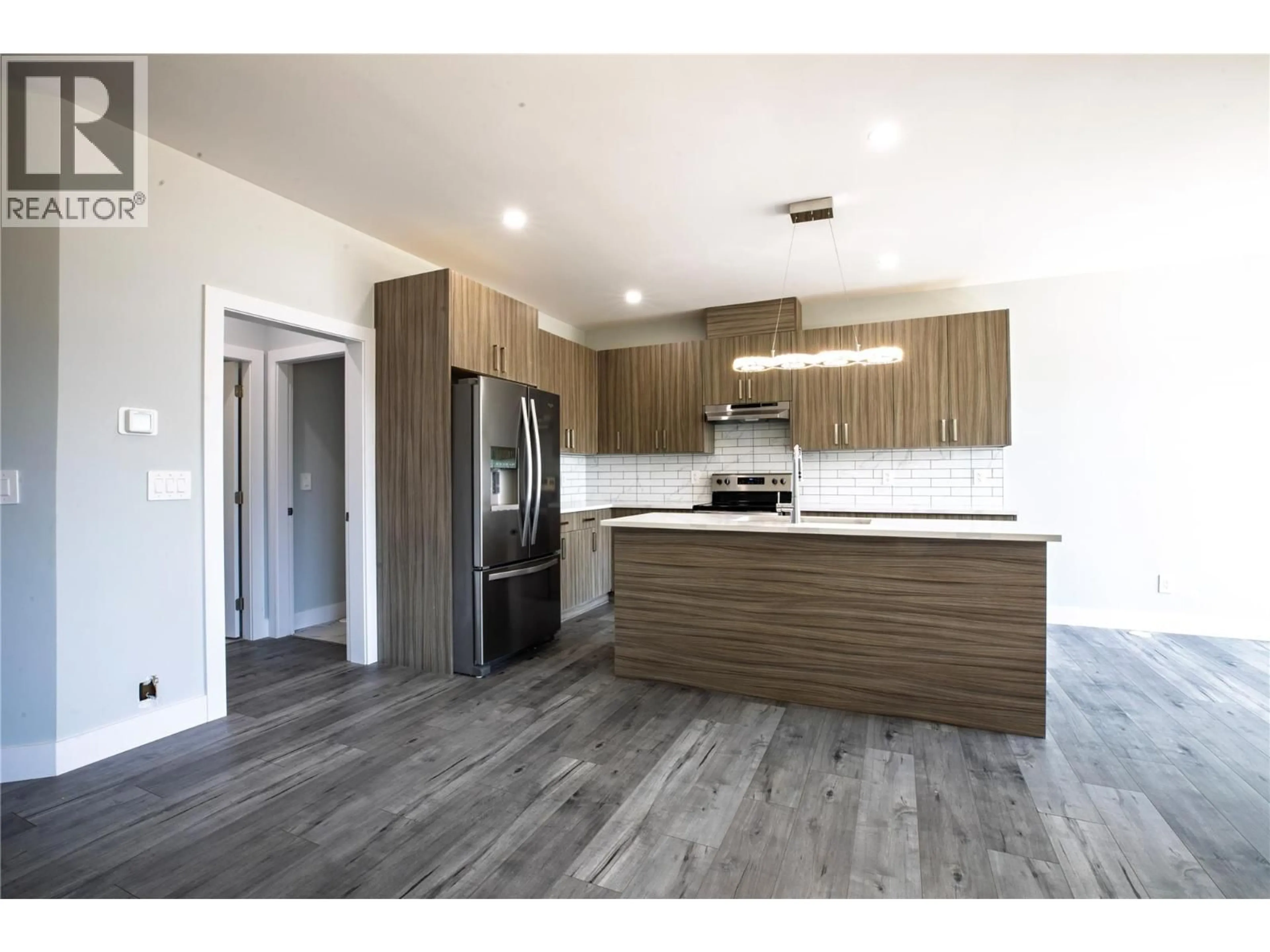 Open concept kitchen, wood/laminate floor for 1347 A ORCHARD DRIVE, Kelowna British Columbia V1Y3V1