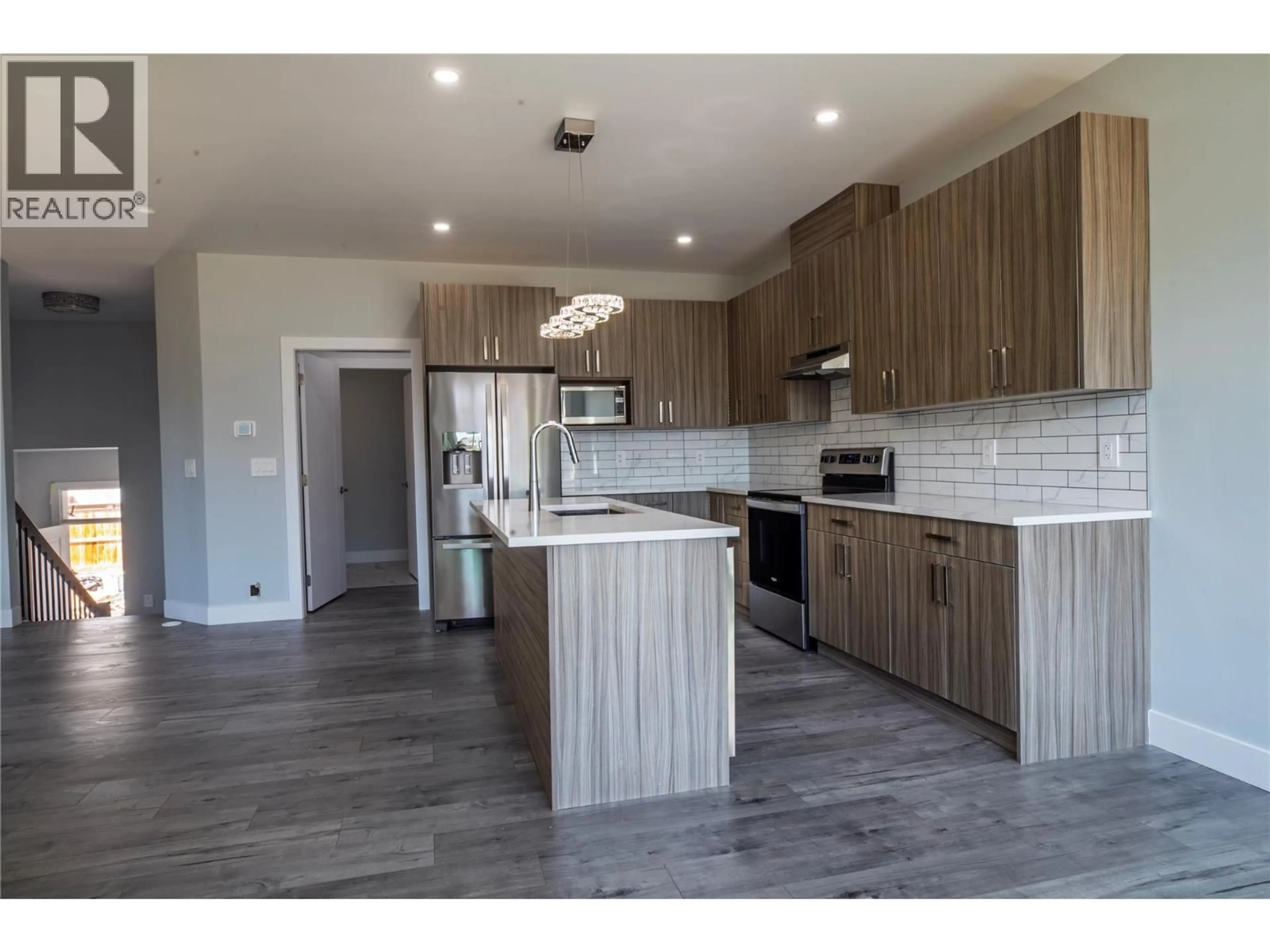 Open concept kitchen, wood/laminate floor for 1347 A ORCHARD DRIVE, Kelowna British Columbia V1Y3V1