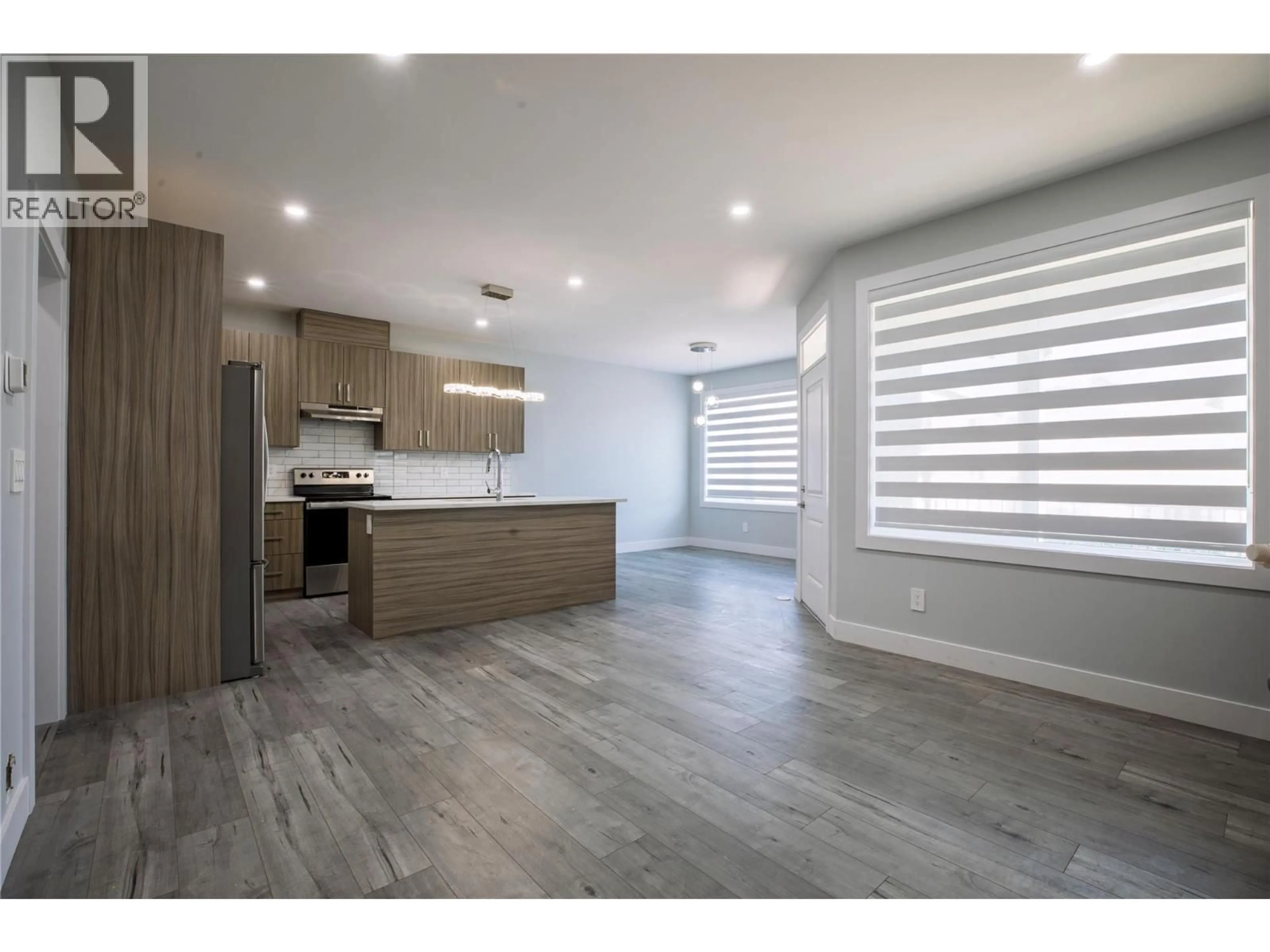 Open concept kitchen, wood/laminate floor for 1347 A ORCHARD DRIVE, Kelowna British Columbia V1Y3V1