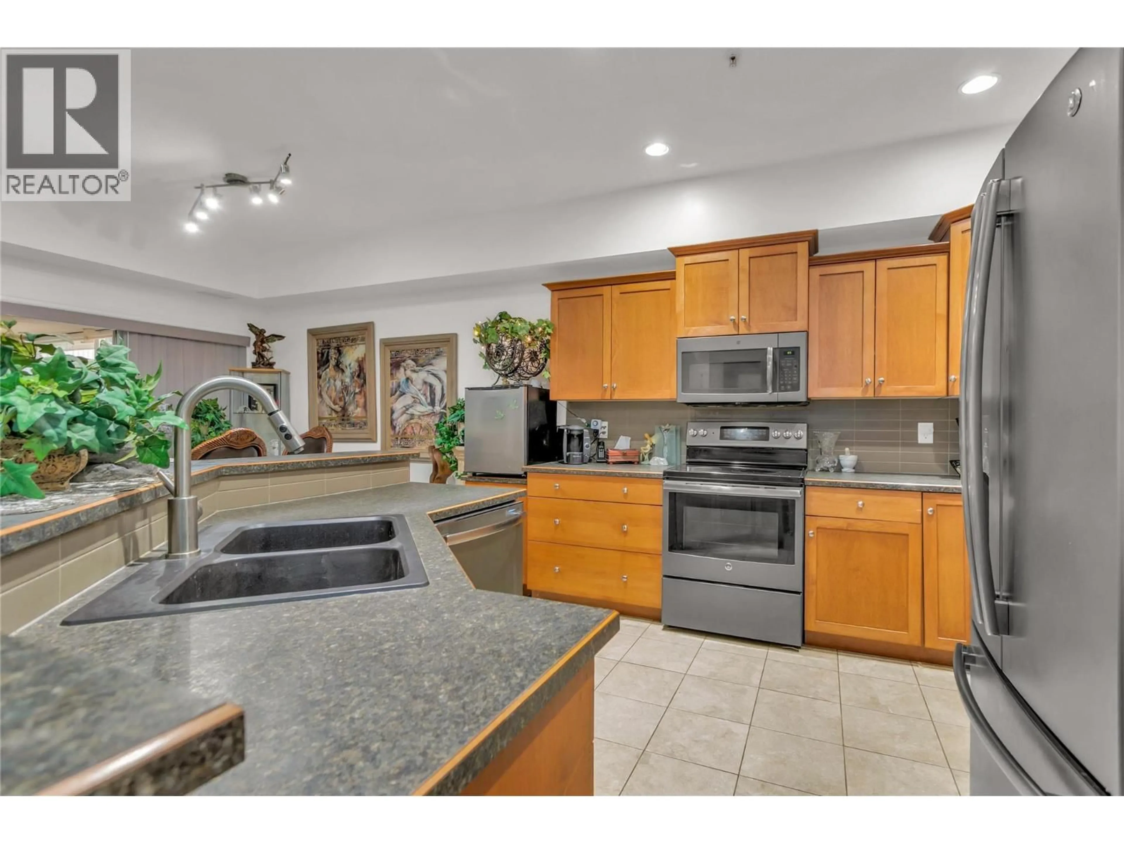 Open concept kitchen, ceramic/tile floor for 104 - 1961 DURNIN ROAD, Kelowna British Columbia V1X7Z6