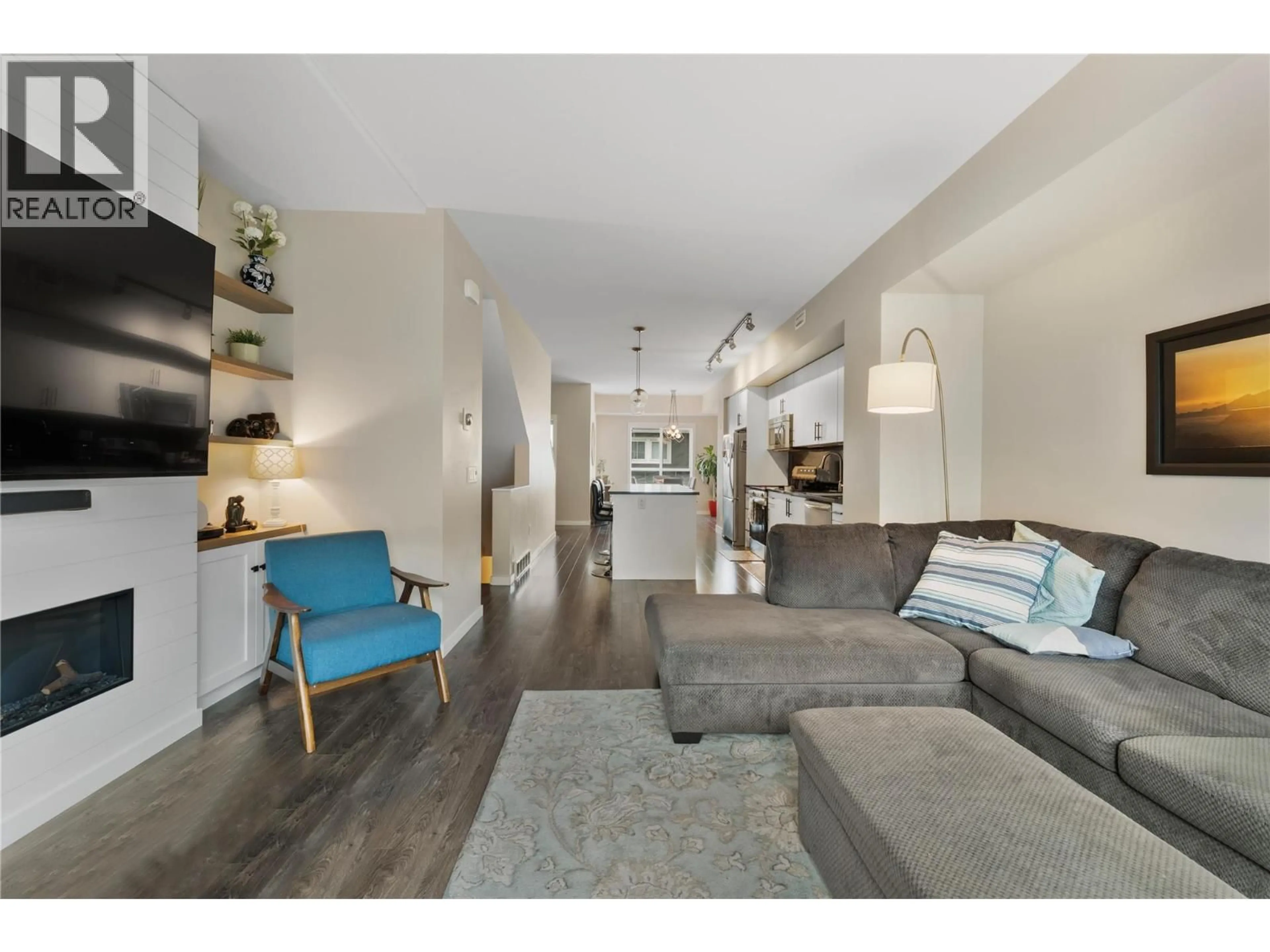 Living room with furniture, wood/laminate floor for 69 - 680 OLD MEADOWS ROAD, Kelowna British Columbia V1W5L4