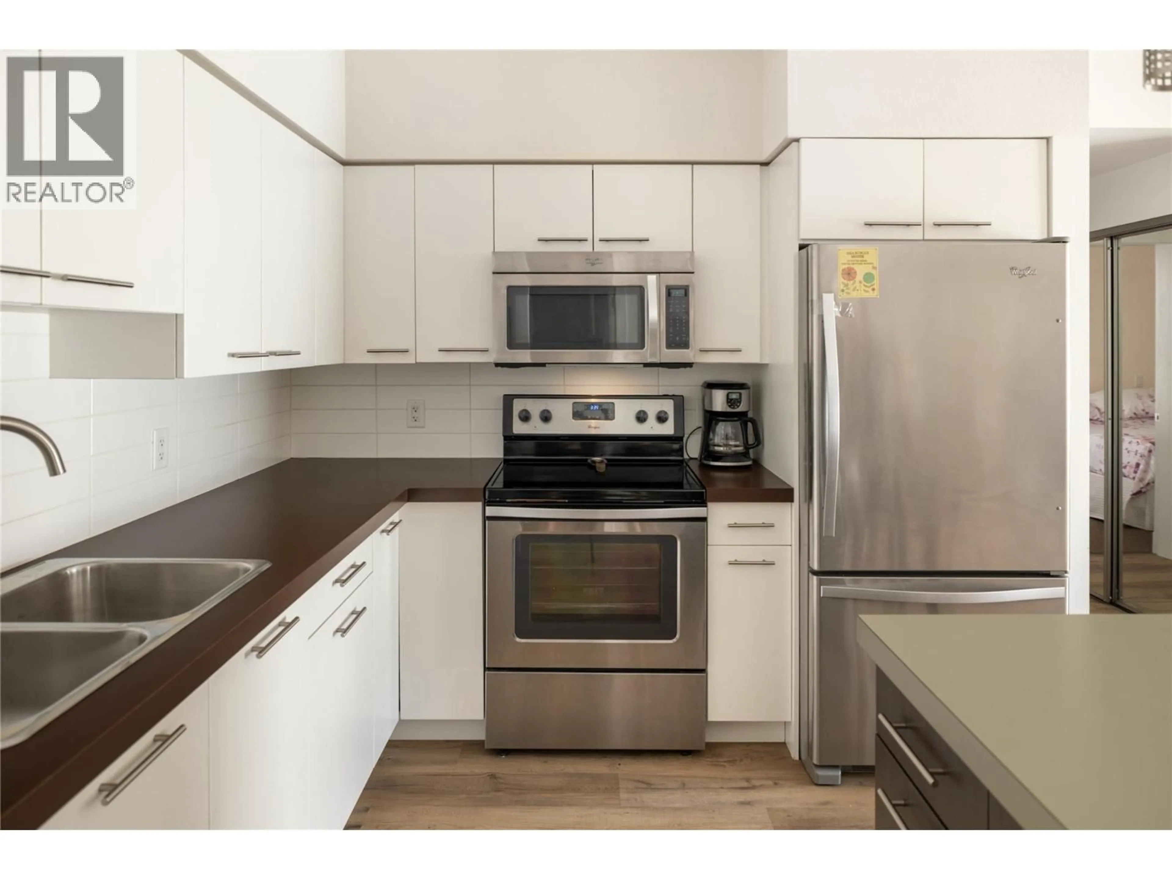 Standard kitchen, wood/laminate floor for 208 - 985 ACADEMY WAY, Kelowna British Columbia V1V3C8