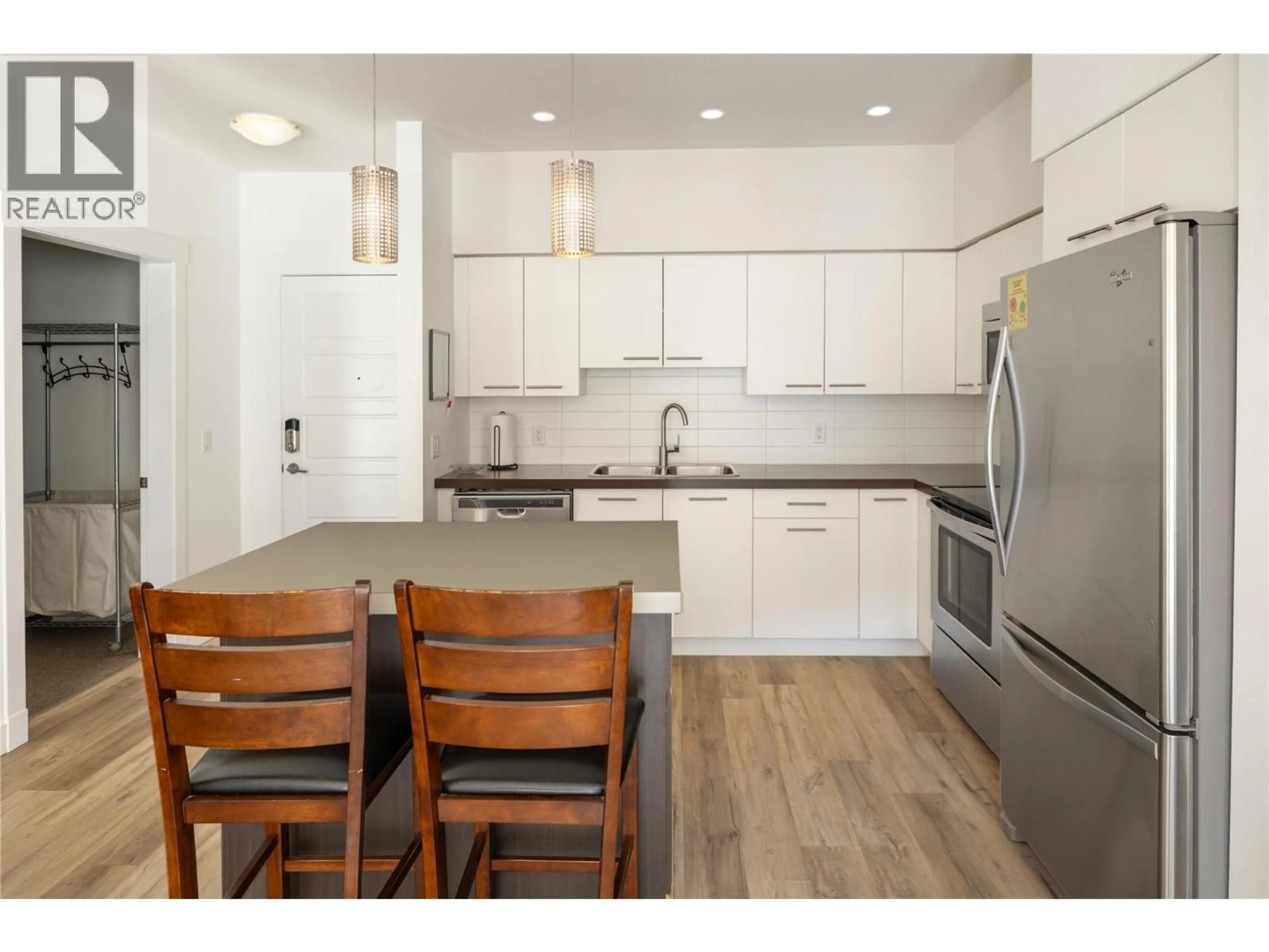 Open concept kitchen, wood/laminate floor for 208 - 985 ACADEMY WAY, Kelowna British Columbia V1V3C8