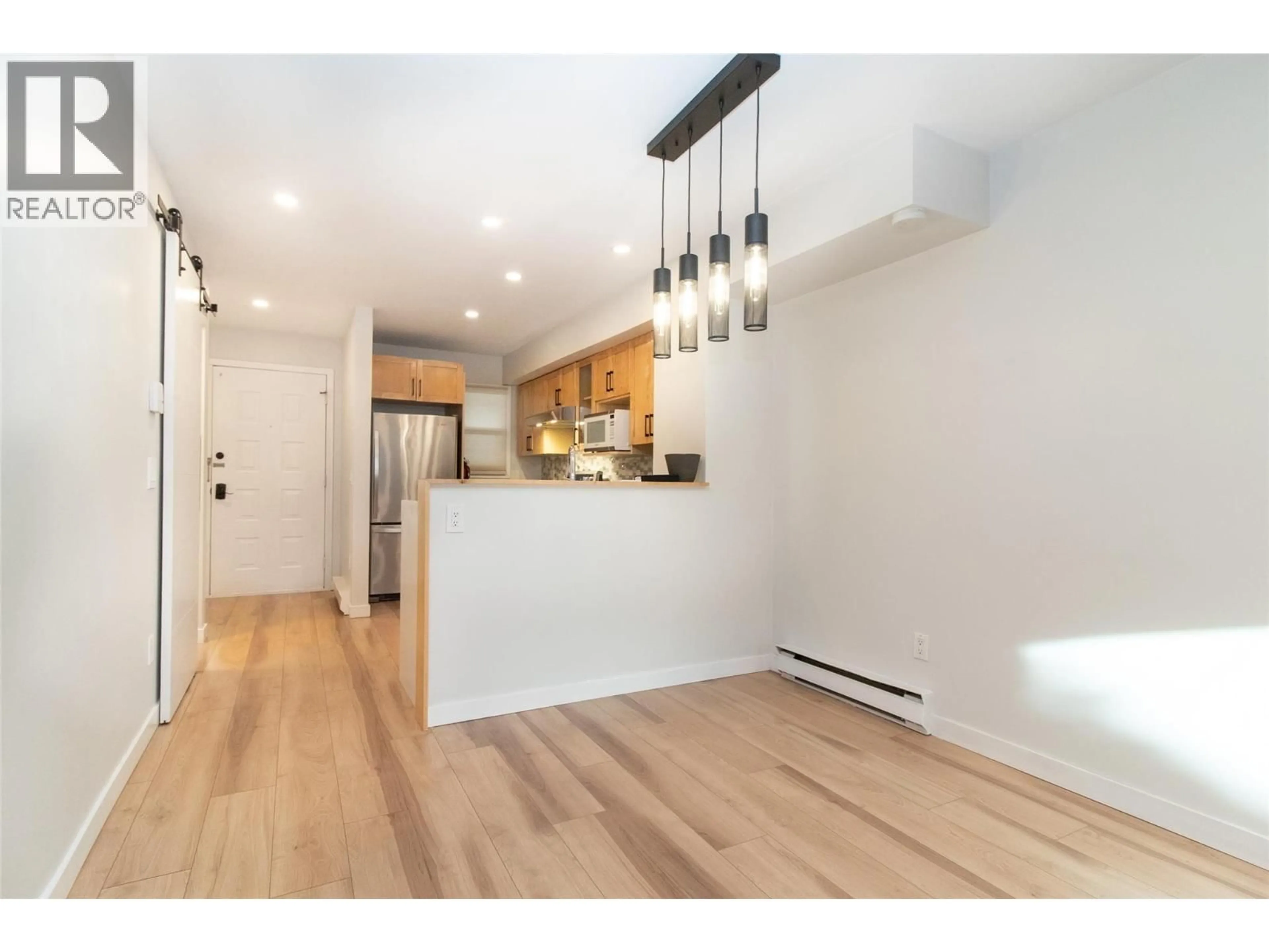 Open concept kitchen, wood/laminate floor for 5 - 500 LESTER ROAD, Kelowna British Columbia V1X6E2