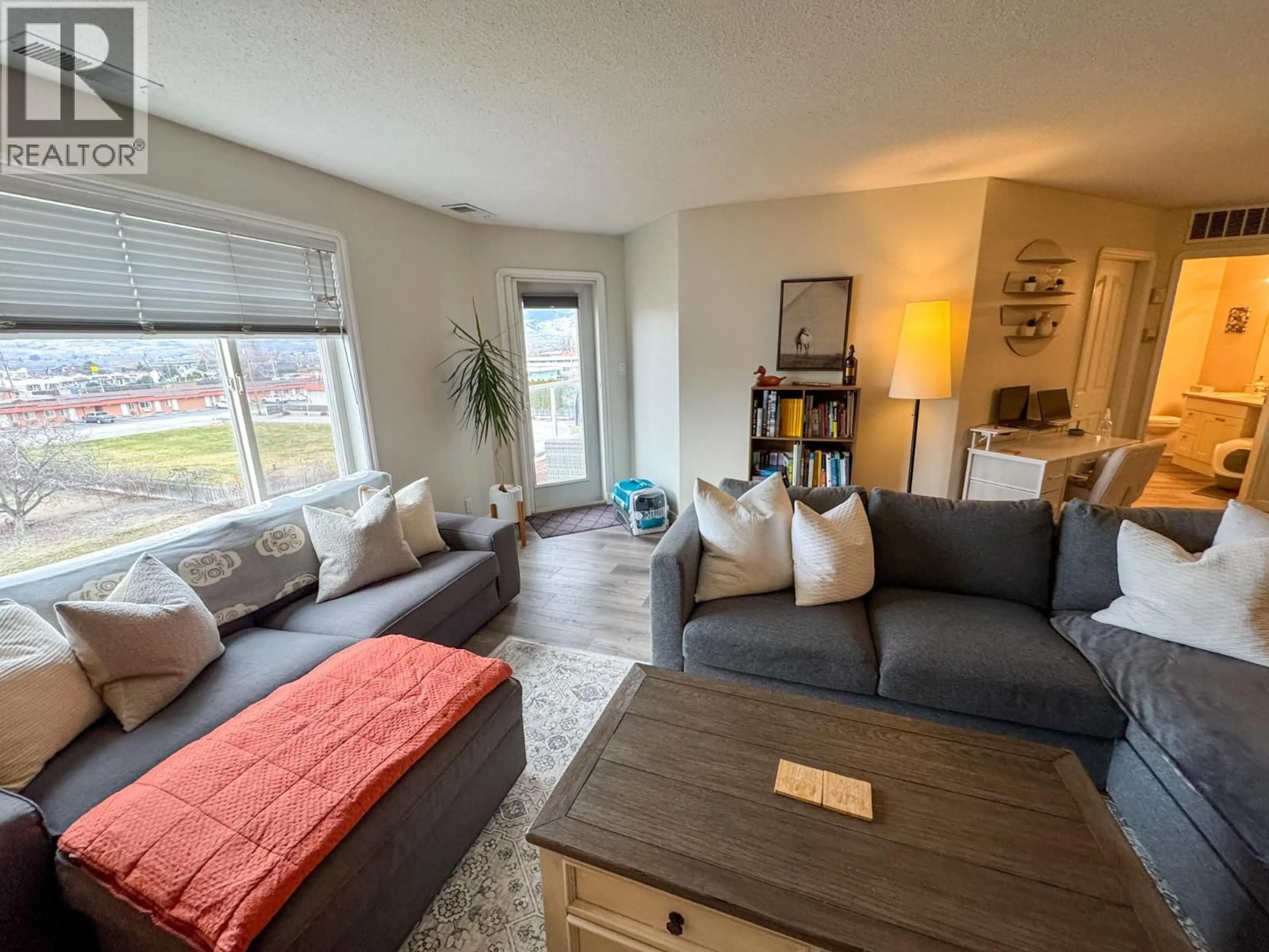 Living room with furniture, wood/laminate floor for 310 - 6805 COTTONWOOD DRIVE, Osoyoos British Columbia V0H1V3