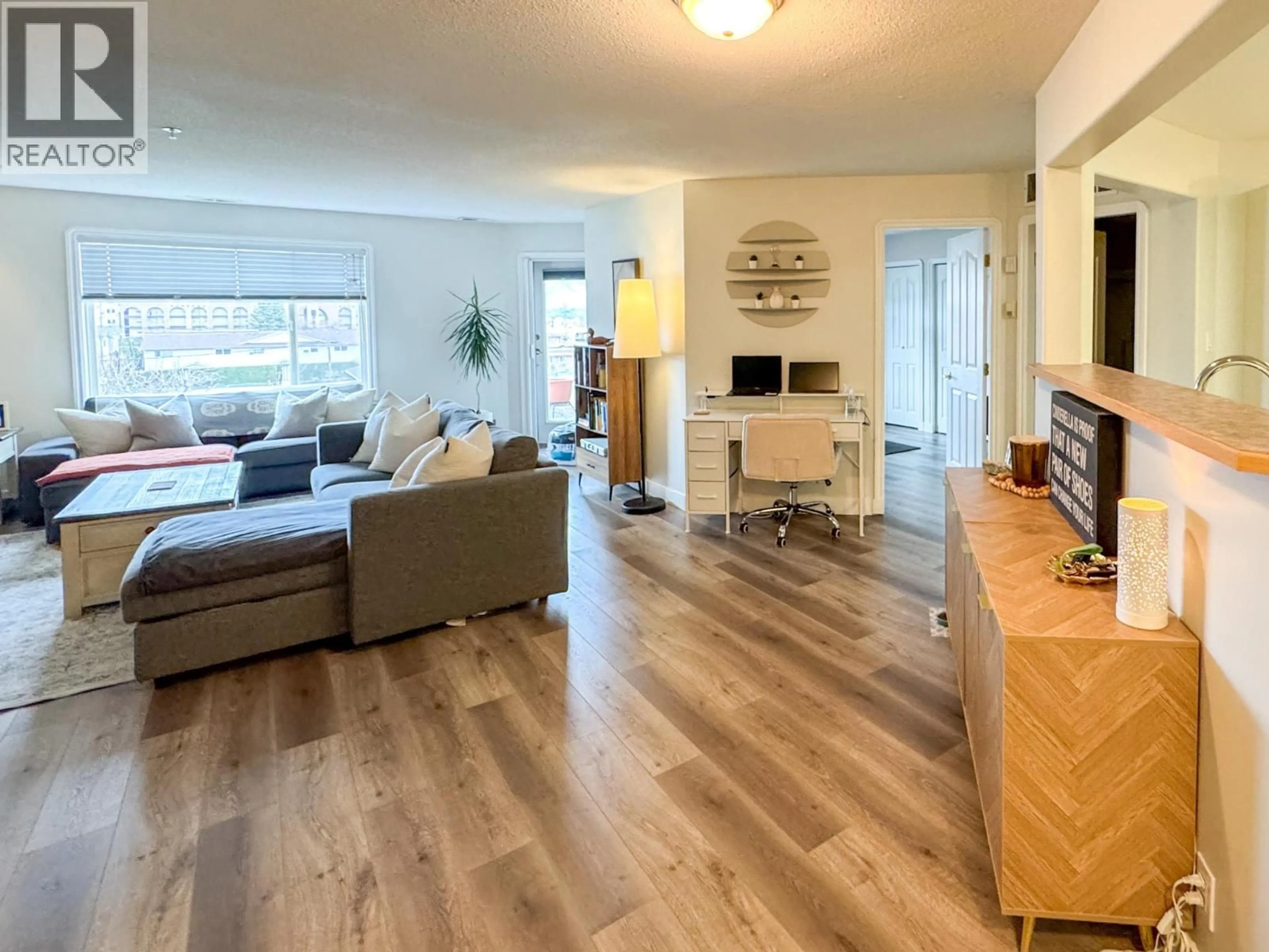 Living room with furniture, wood/laminate floor for 310 - 6805 COTTONWOOD DRIVE, Osoyoos British Columbia V0H1V3