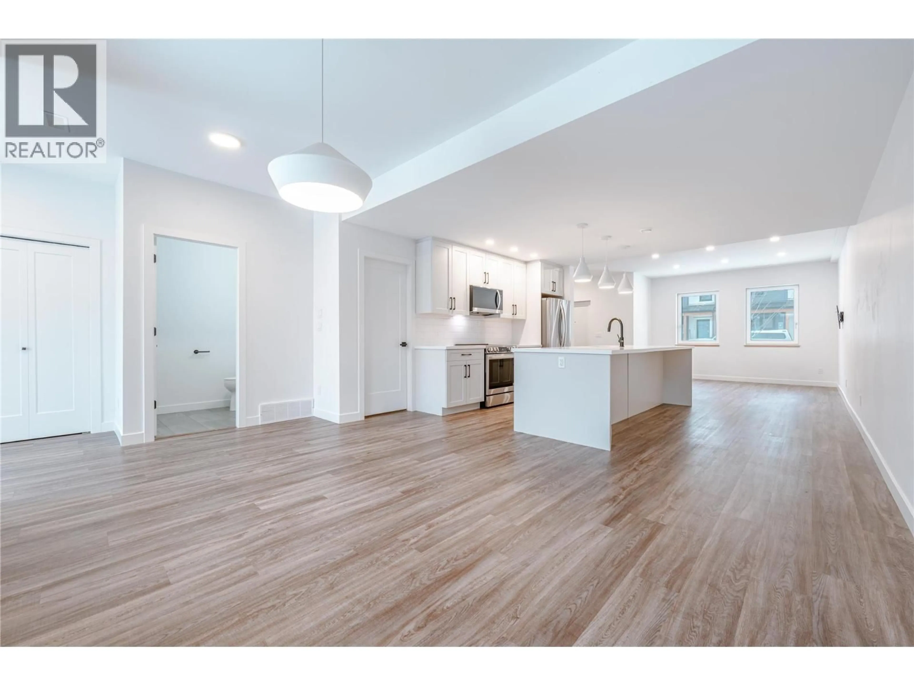 Open concept kitchen, wood/laminate floor for 1039 KEYSTONE CRESCENT, Revelstoke British Columbia V0E2S3