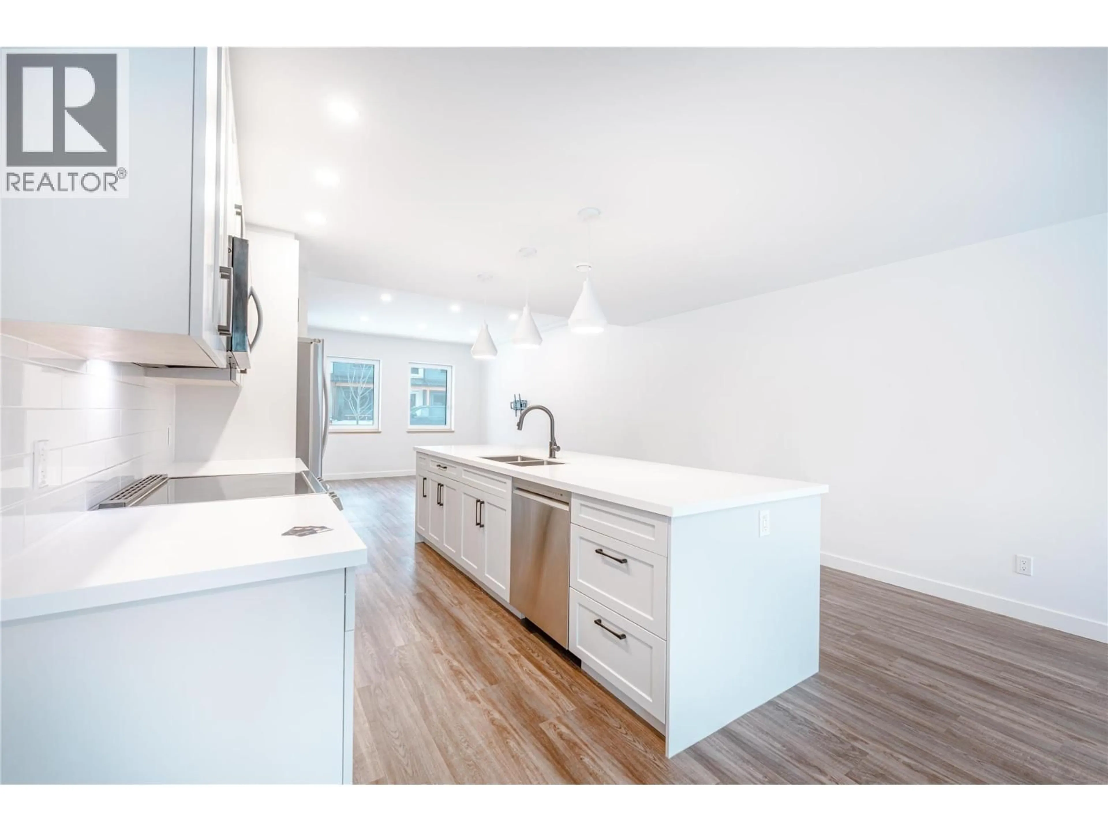 Open concept kitchen, wood/laminate floor for 1039 KEYSTONE CRESCENT, Revelstoke British Columbia V0E2S3