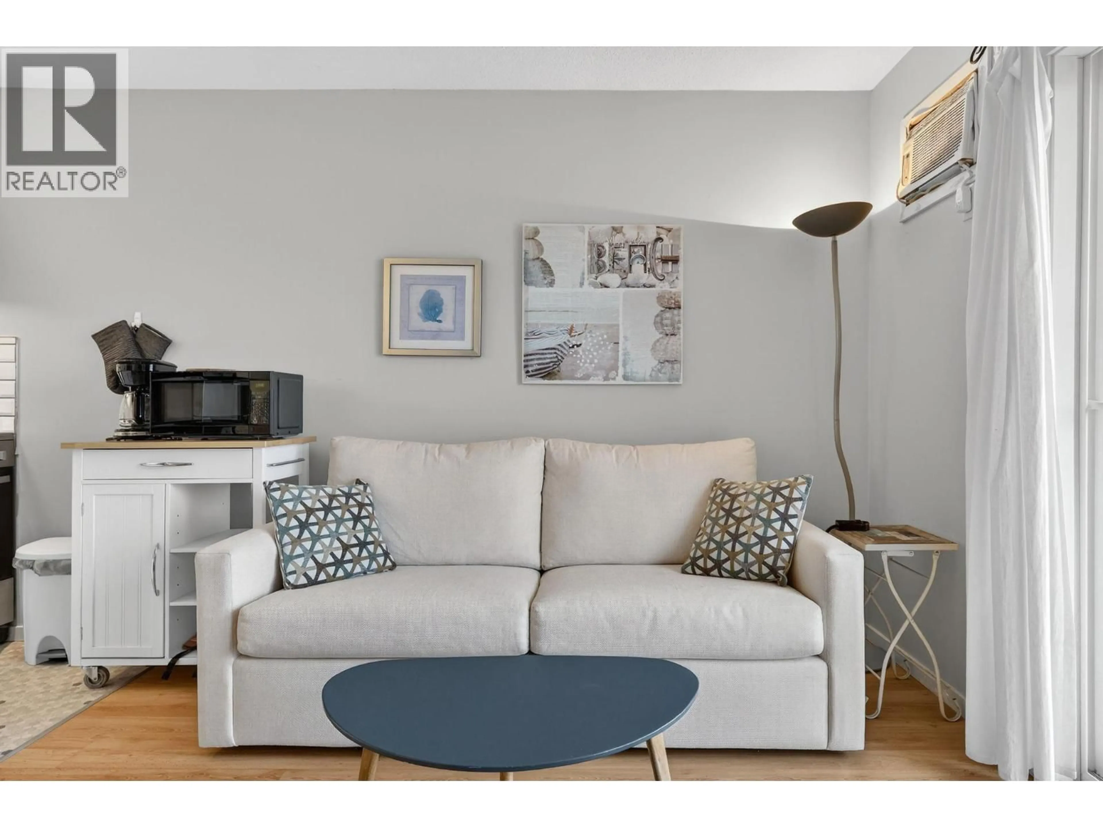 Living room with furniture, wood/laminate floor for 105 - 3050 SECLUSION BAY ROAD, Westbank British Columbia V0H2A0