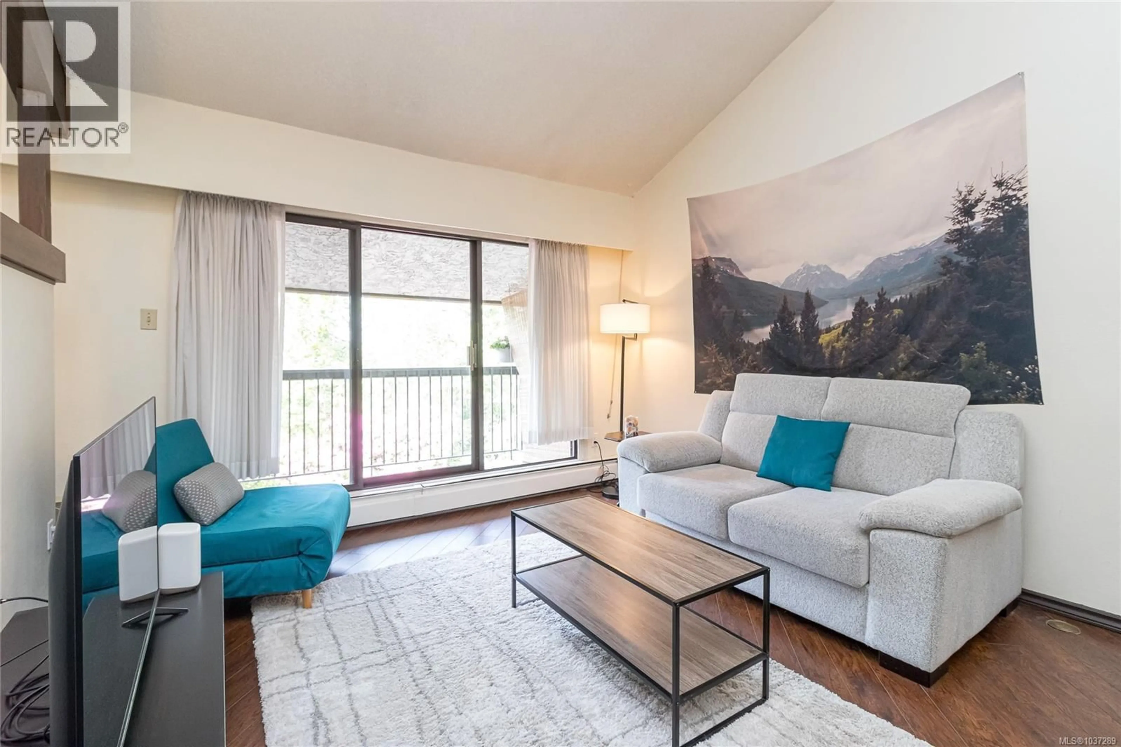 Living room with furniture, wood/laminate floor for 407 - 1009 MCKENZIE AVENUE, Saanich British Columbia V8X4B1