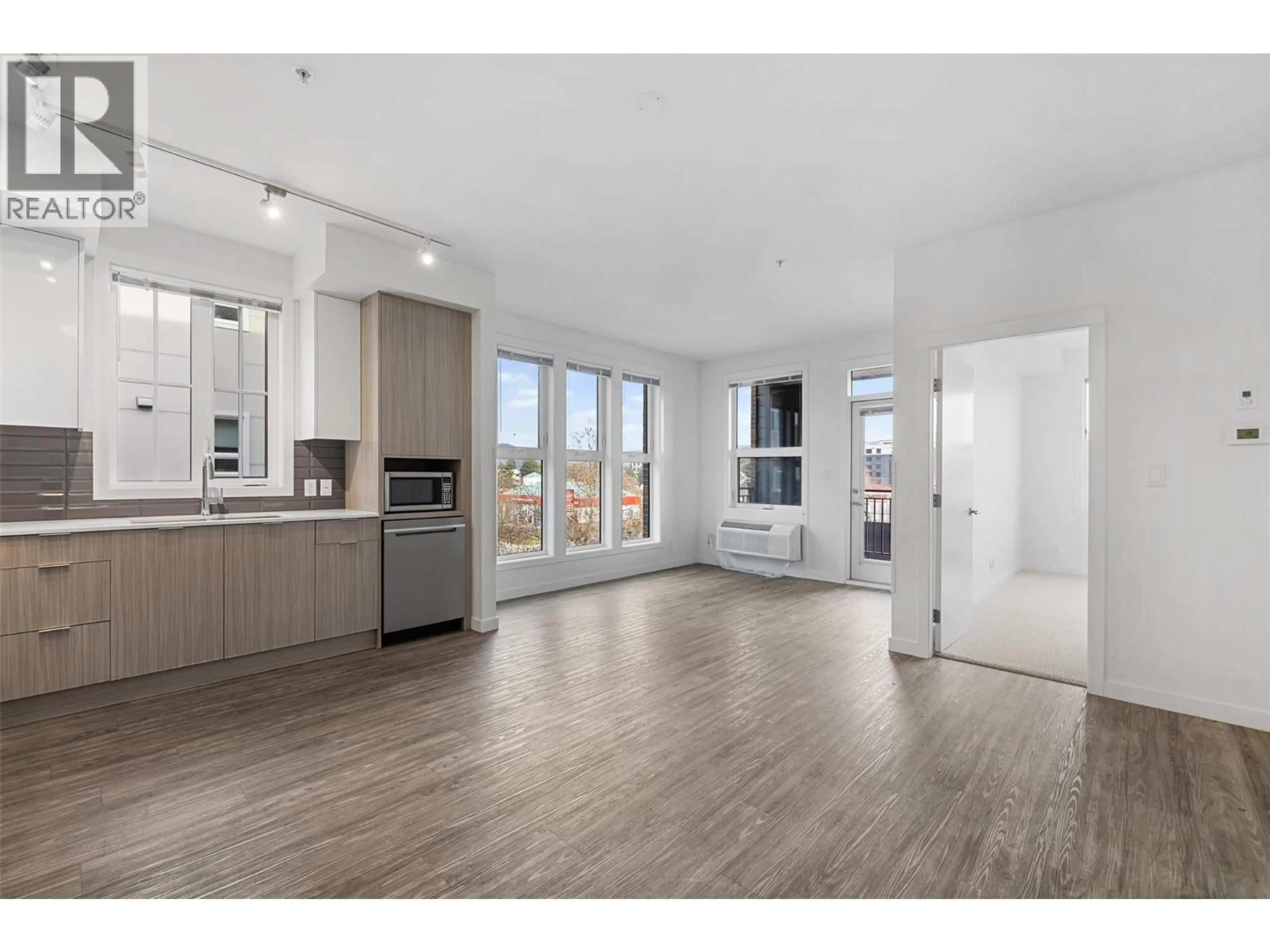 Open concept kitchen, wood/laminate floor for 315 - 1800 RICHTER STREET, Kelowna British Columbia V1Y6C7