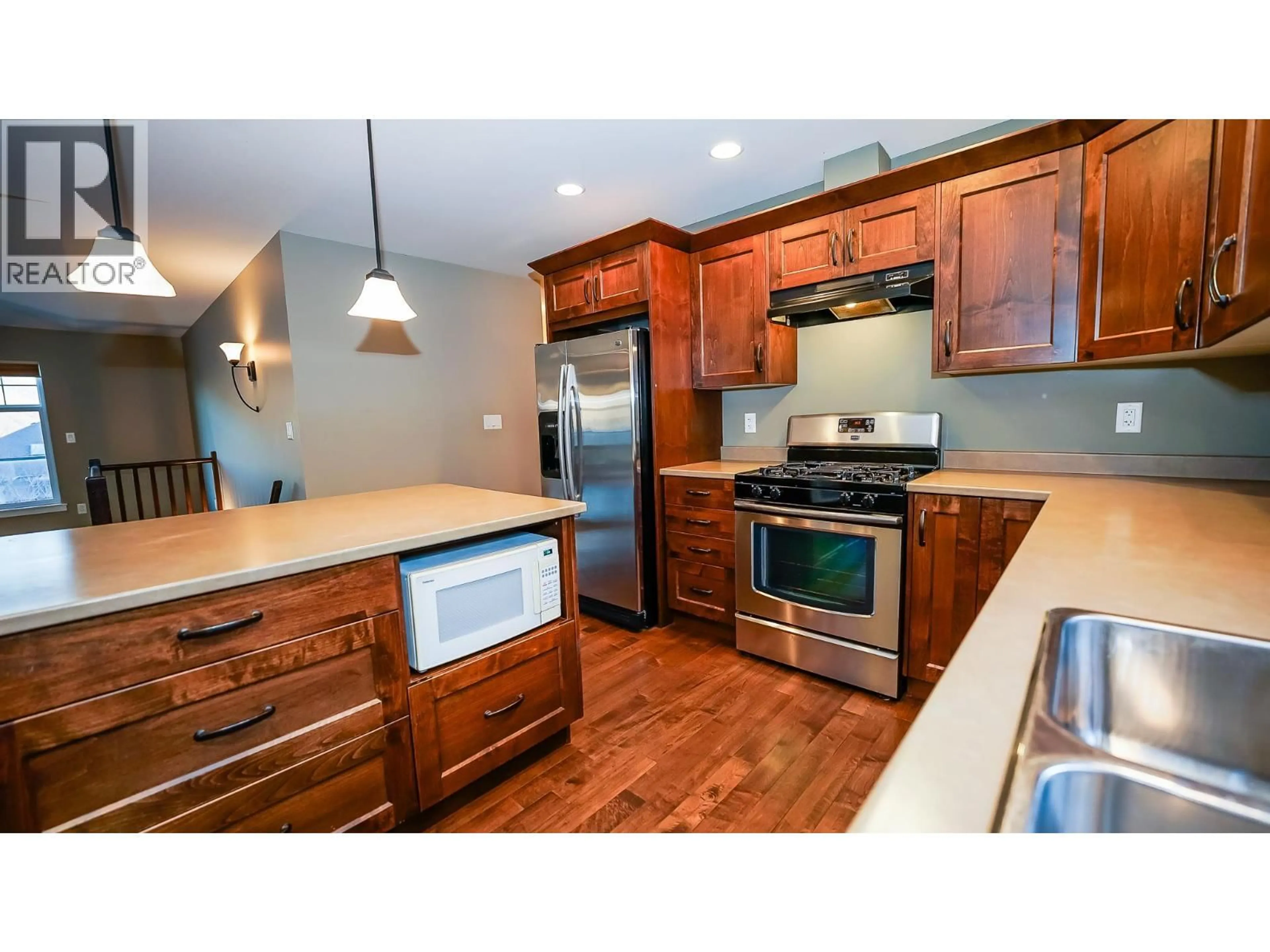 Open concept kitchen, wood/laminate floor for 2023 SADDLEBACK DRIVE, Kamloops British Columbia V2B0A6
