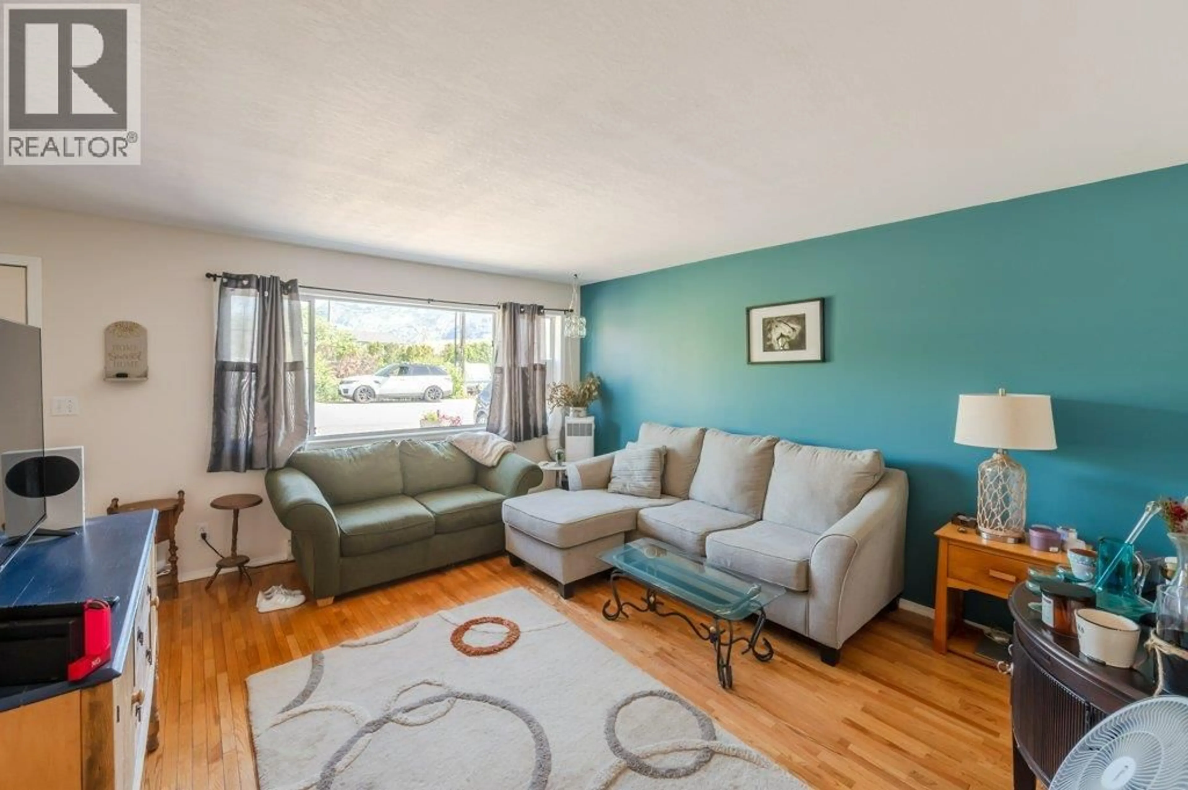 Living room with furniture, wood/laminate floor for 20 CACTUS CRESCENT, Osoyoos British Columbia V0H1V1