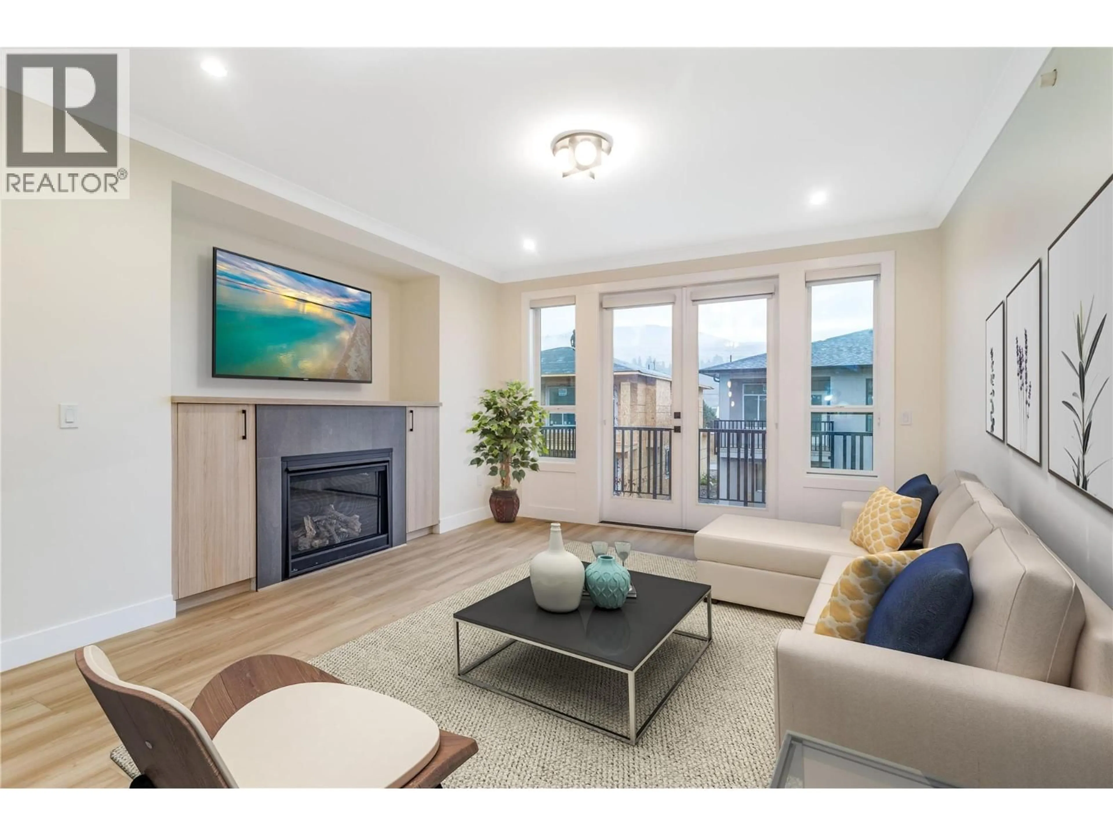 Living room with furniture, wood/laminate floor for 23 - 19950 MCCARTHY ROAD, Lake Country British Columbia