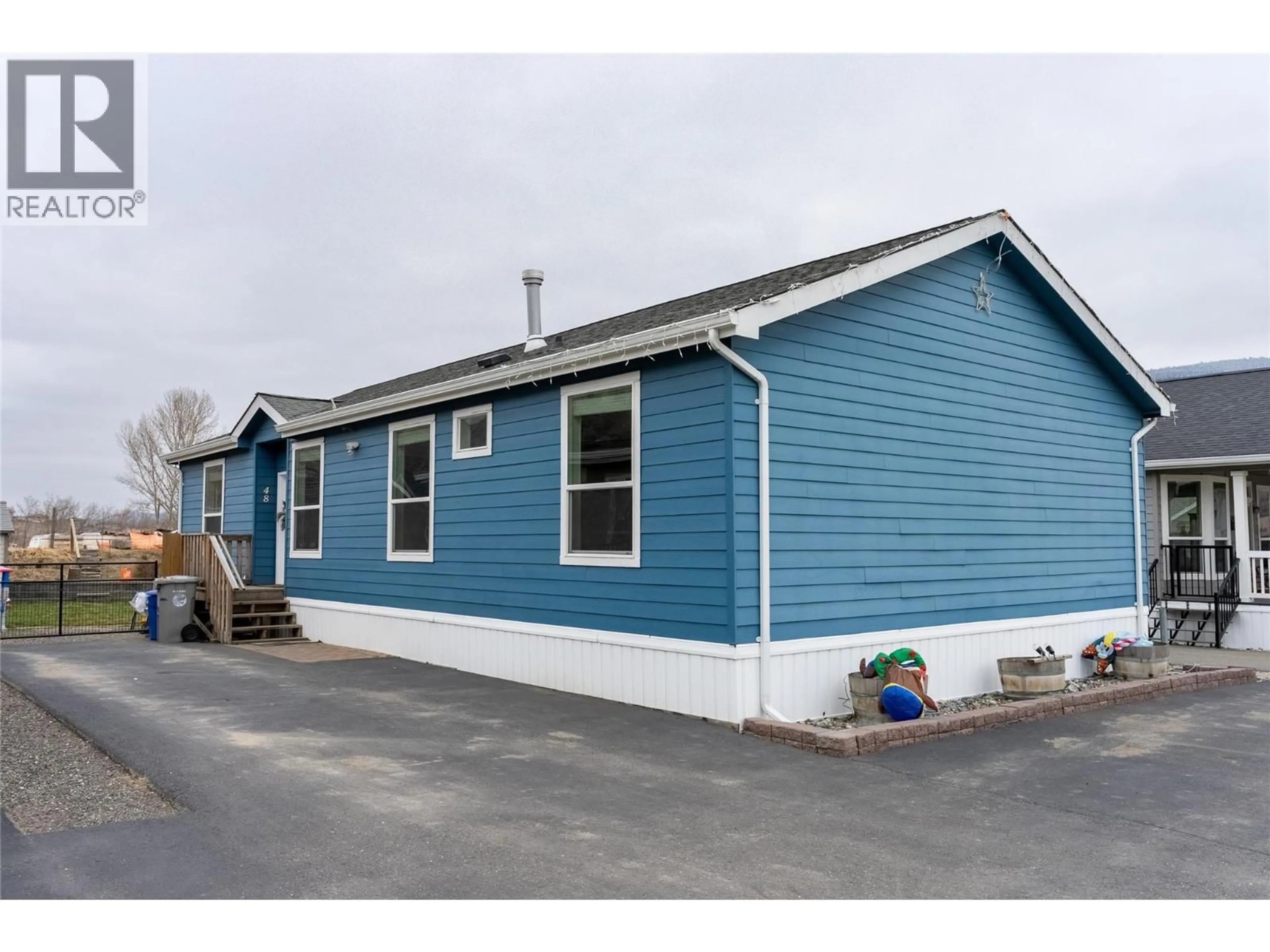 Home with vinyl exterior material, street for 48 - 712 SHUSWAP  E ROAD, Kamloops British Columbia V2H0C8