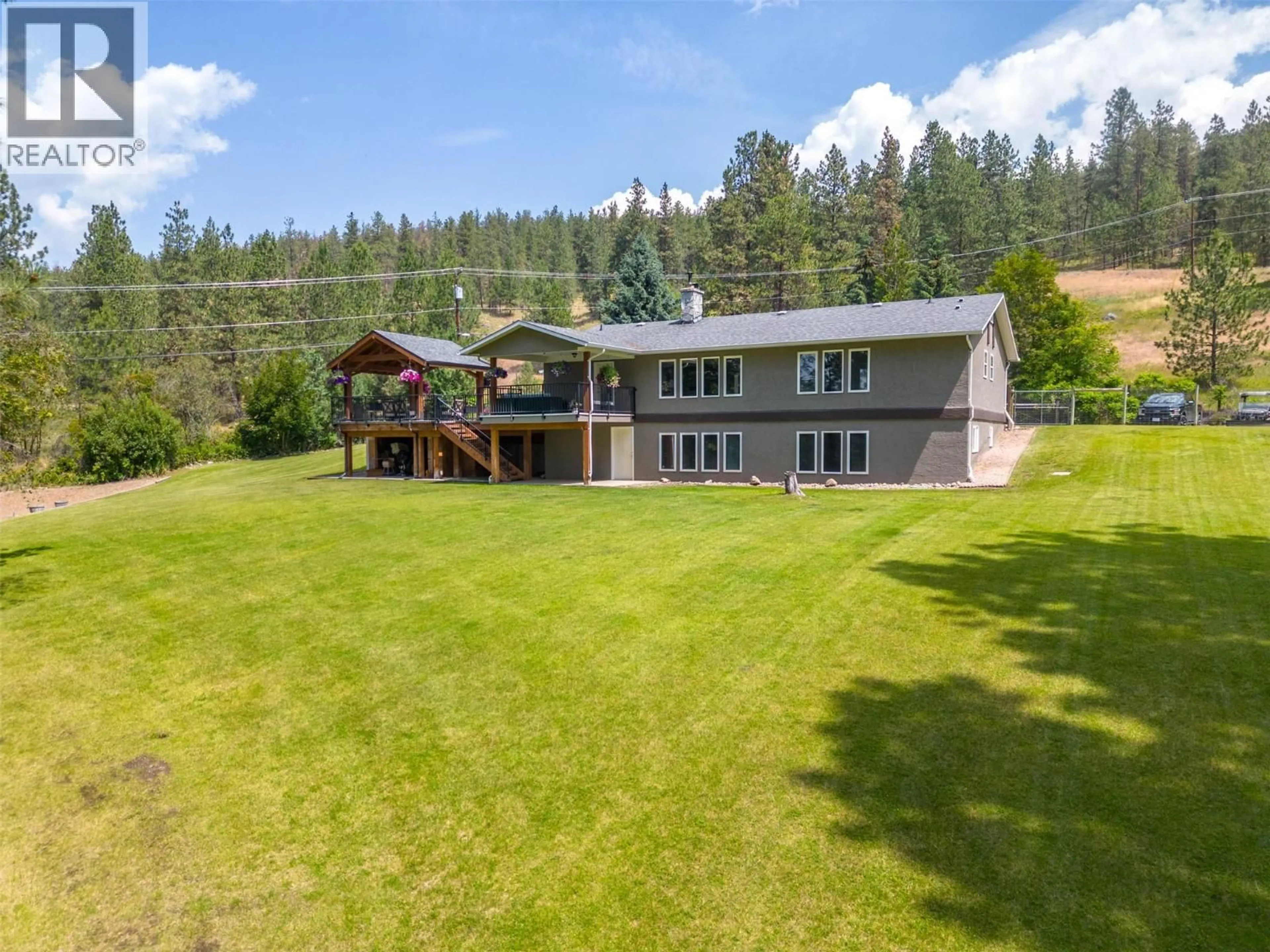 A pic from outside/outdoor area/front of a property/back of a property/a pic from drone, mountain view for 6051 POSTILL LAKE ROAD, Kelowna British Columbia V1X7V3