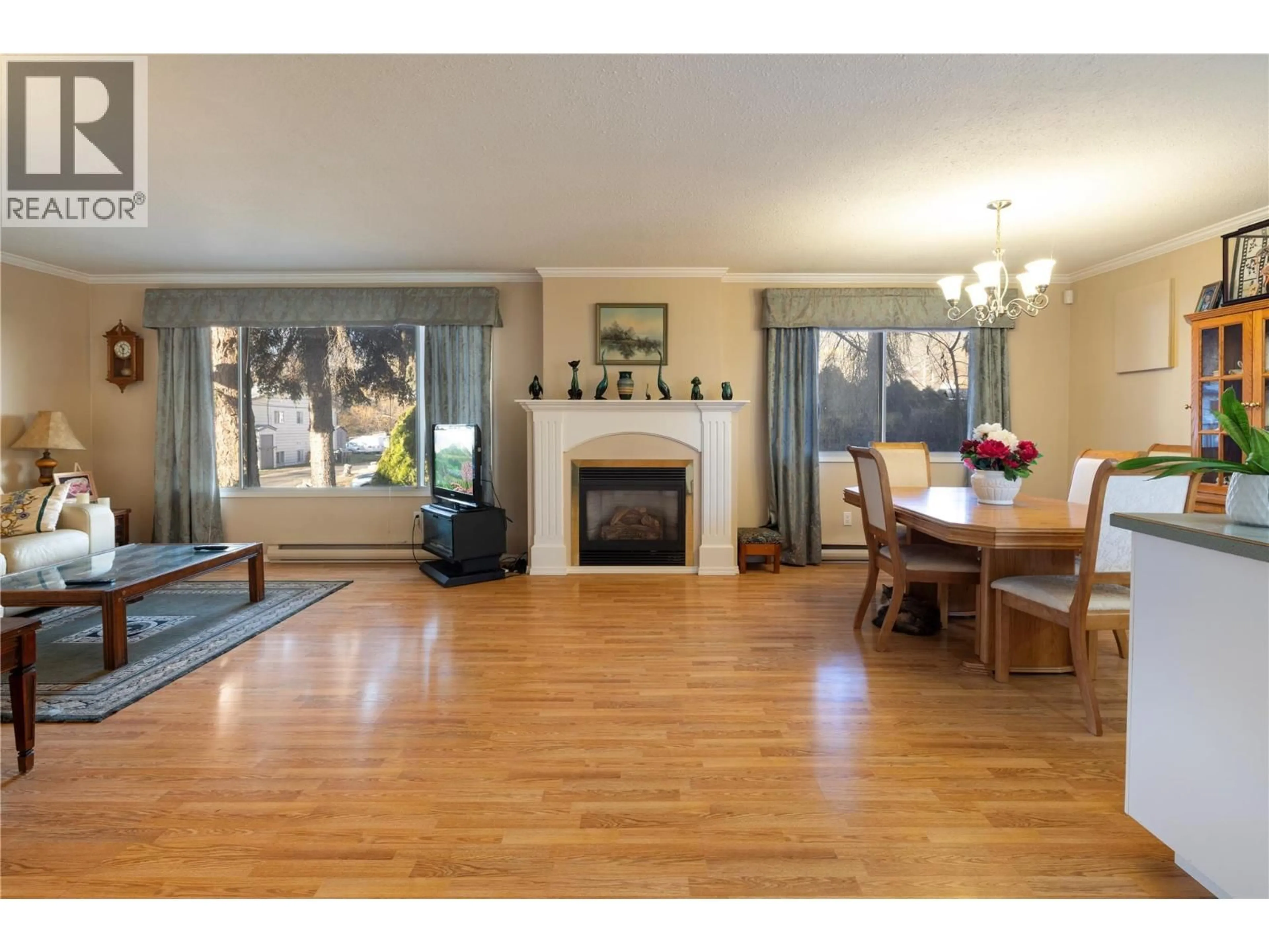 Living room with furniture, wood/laminate floor for 1607 45 STREET, Vernon British Columbia V1T7P9