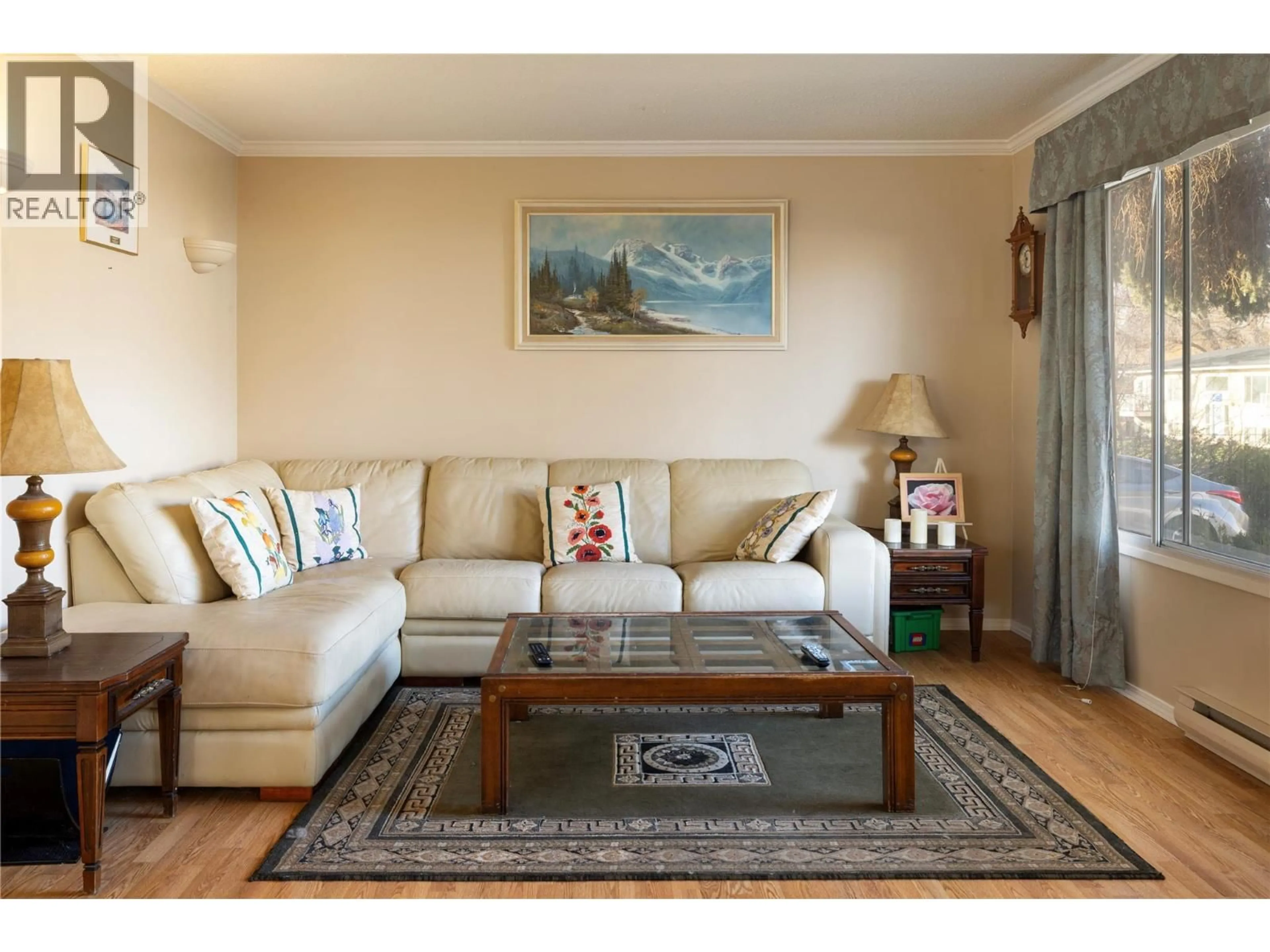 Living room with furniture, wood/laminate floor for 1607 45 STREET, Vernon British Columbia V1T7P9