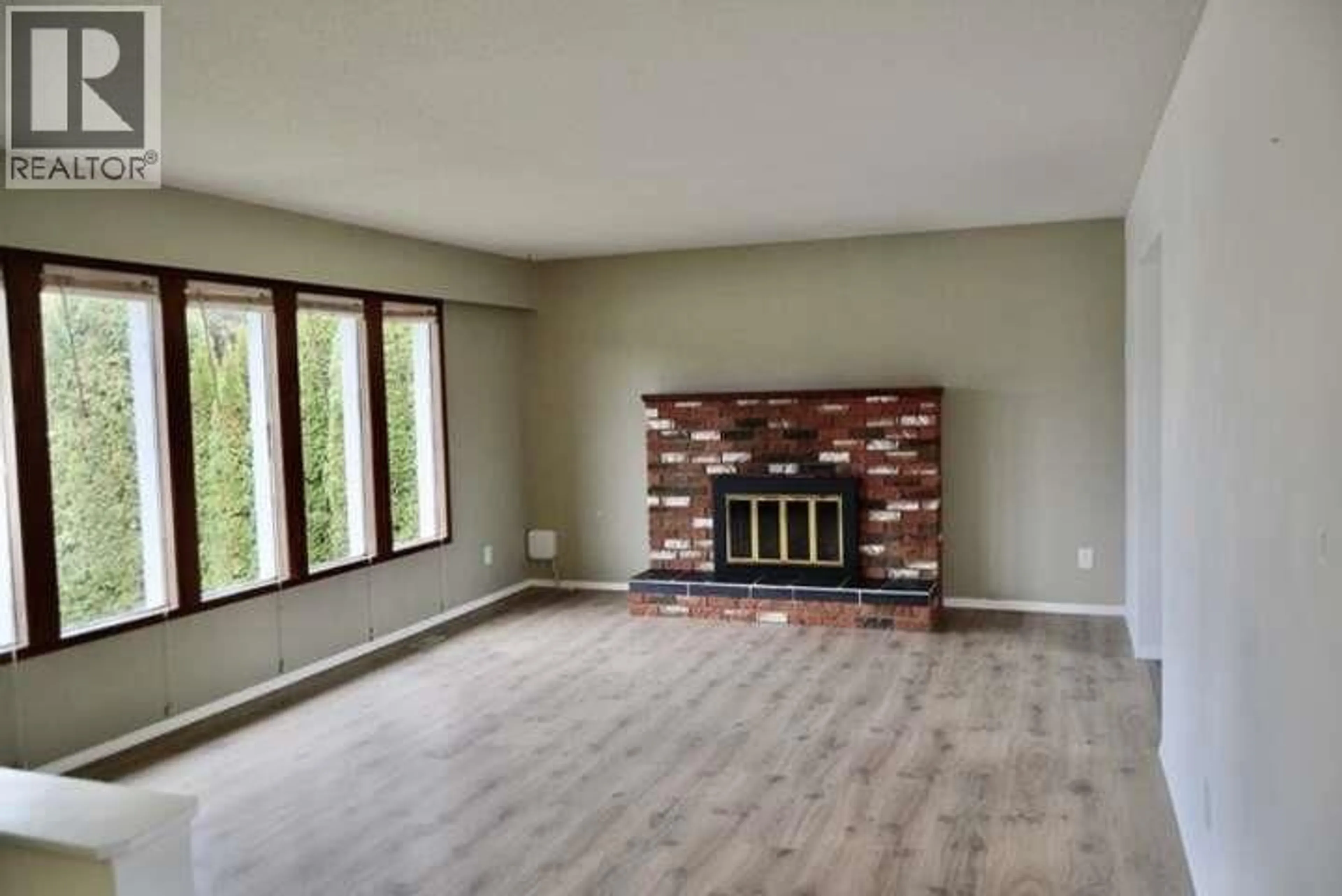 Living room with furniture, wood/laminate floor for 1007 LANFRANCO ROAD, Kelowna British Columbia V1W3X2