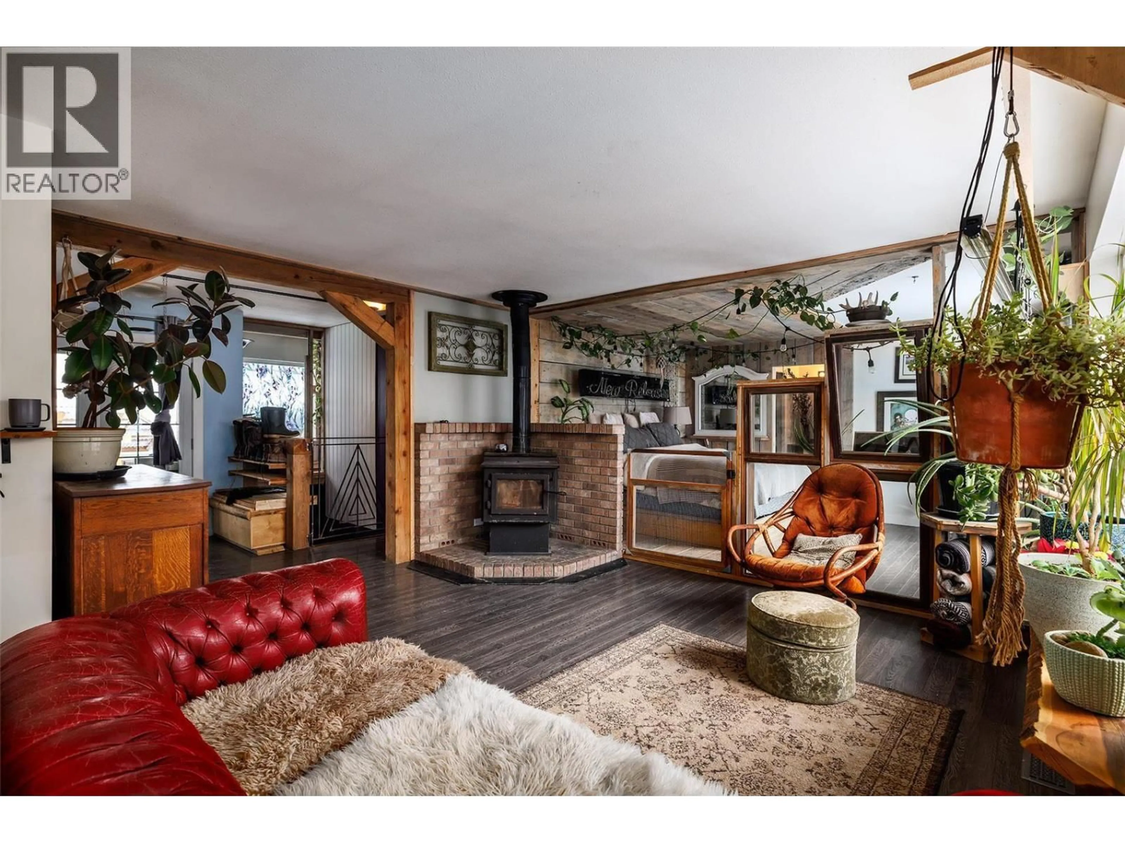 Living room with furniture, wood/laminate floor for 1813 CARDINAL CREEK ROAD, Kelowna British Columbia V1P1J3