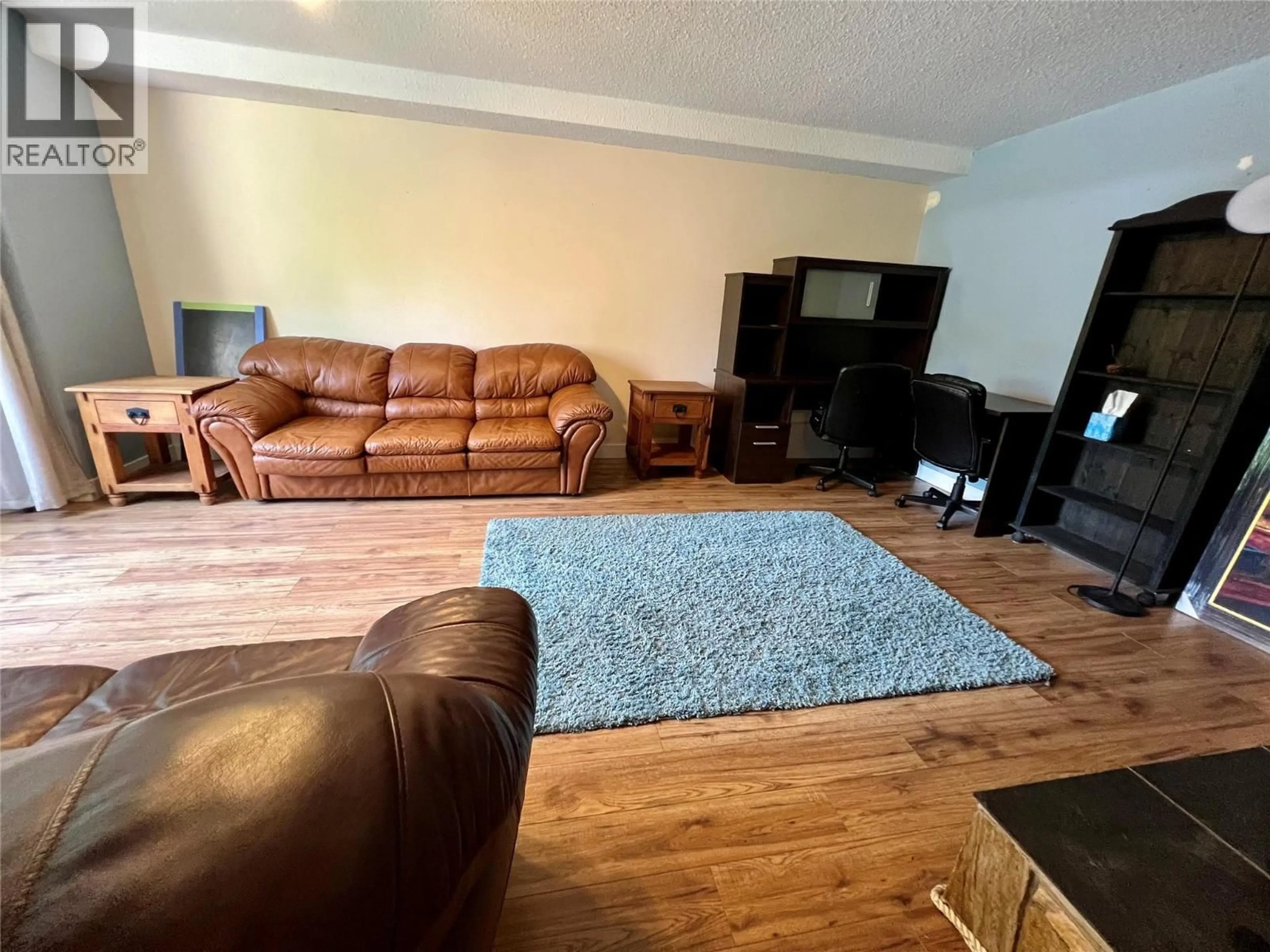 Living room with furniture, wood/laminate floor for 2520 9TH AVENUE, Castlegar British Columbia V1N2Y8