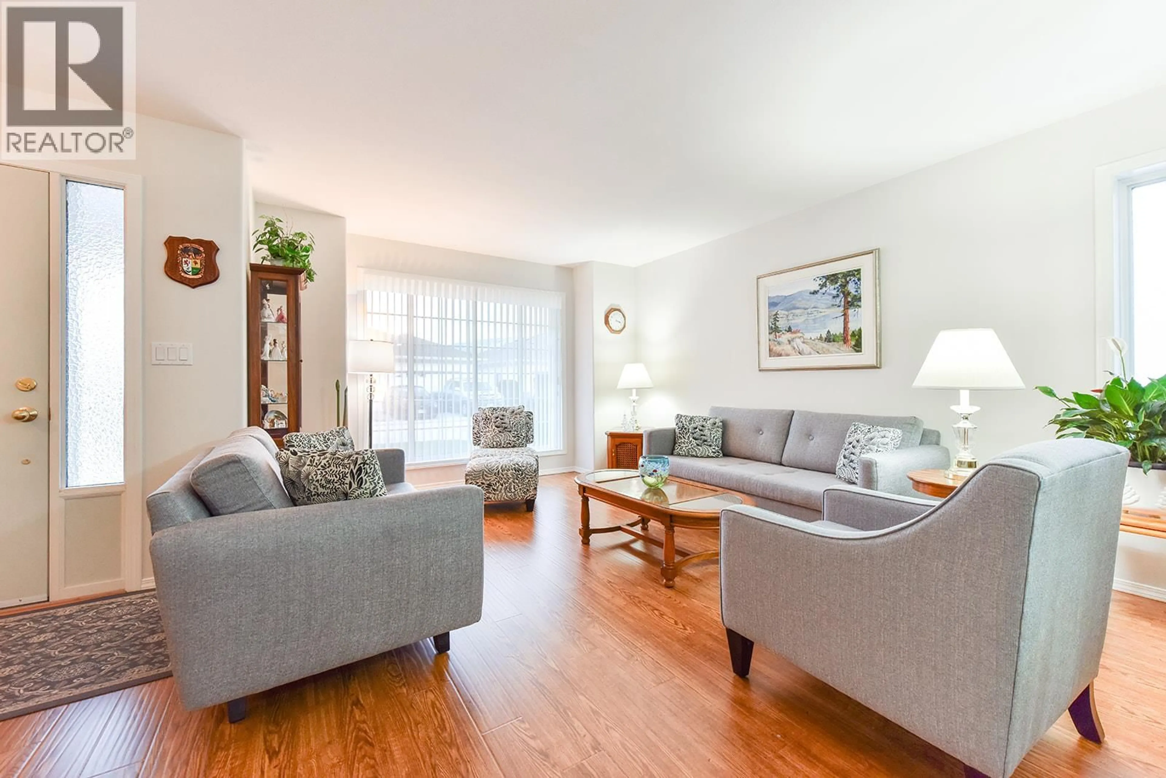 Living room with furniture, wood/laminate floor for 539 RED WING DRIVE, Penticton British Columbia V2A8N7
