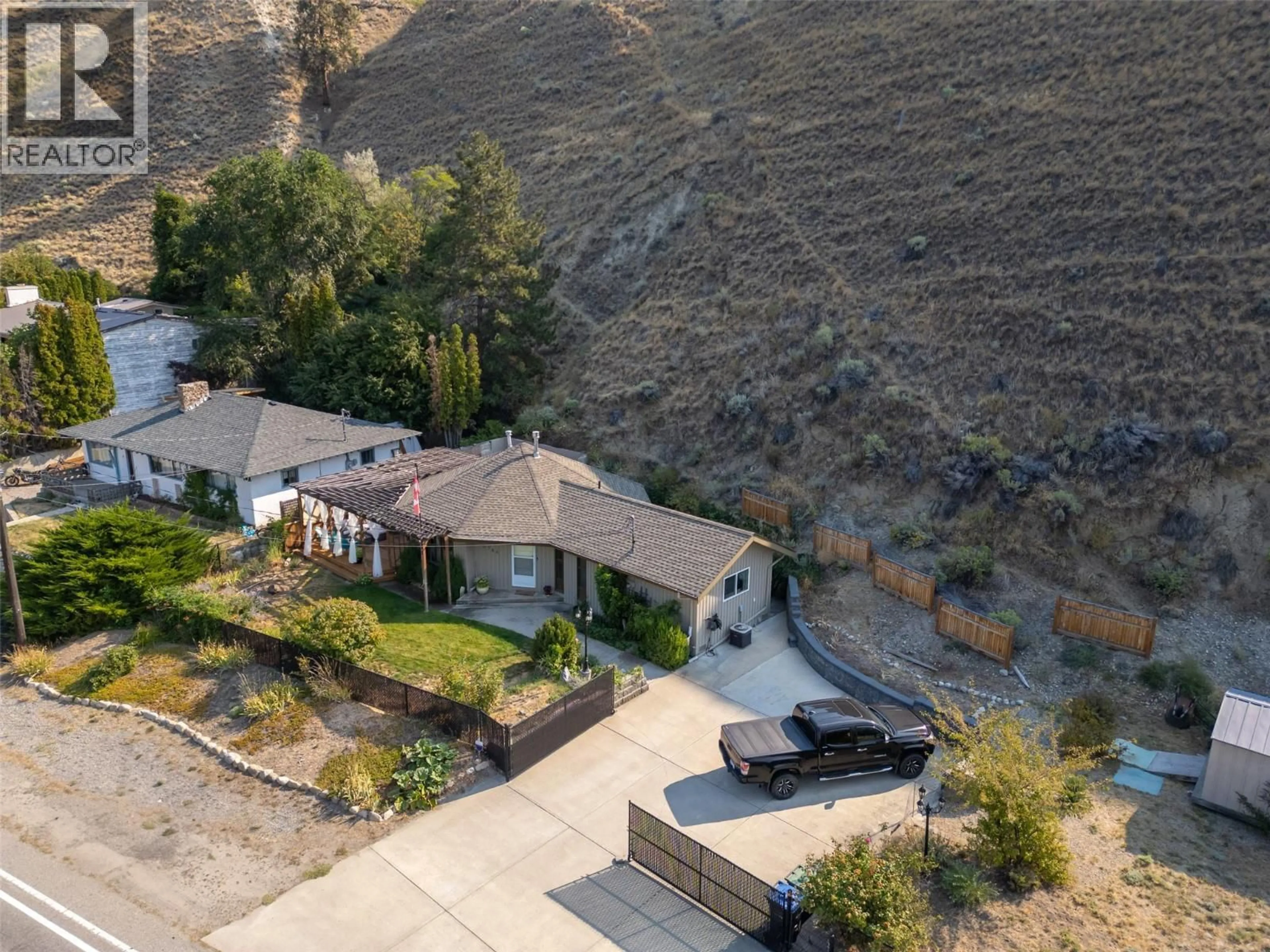A pic from outside/outdoor area/front of a property/back of a property/a pic from drone, mountain view for 4744 LAKESIDE ROAD, Penticton British Columbia V2A8W6