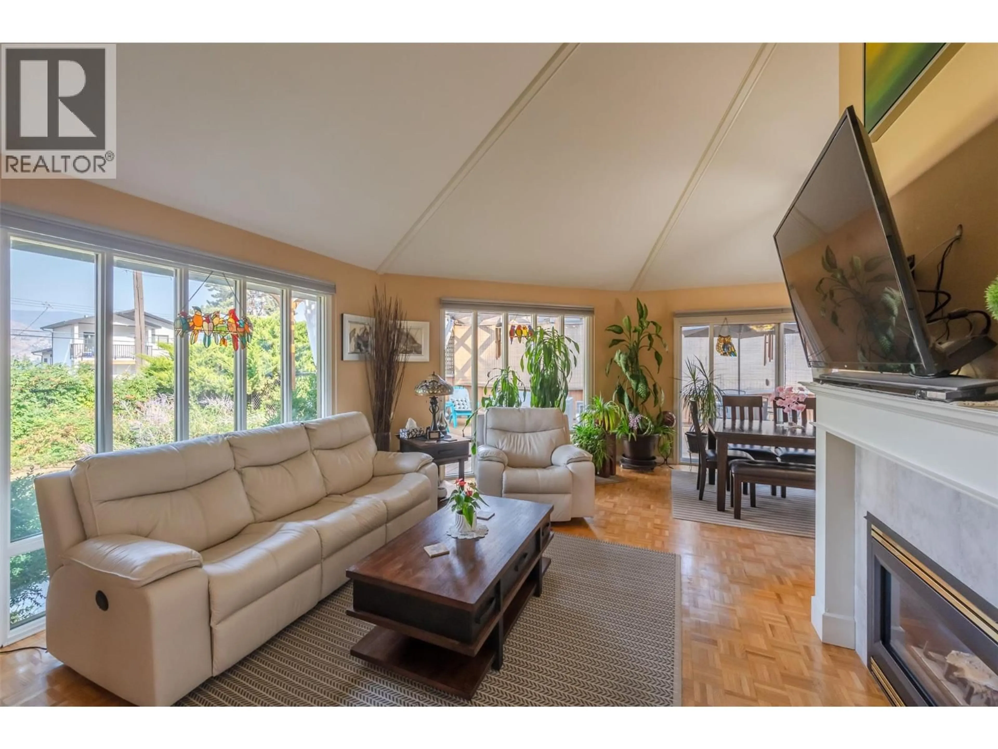 Living room with furniture, wood/laminate floor for 4744 LAKESIDE ROAD, Penticton British Columbia V2A8W6