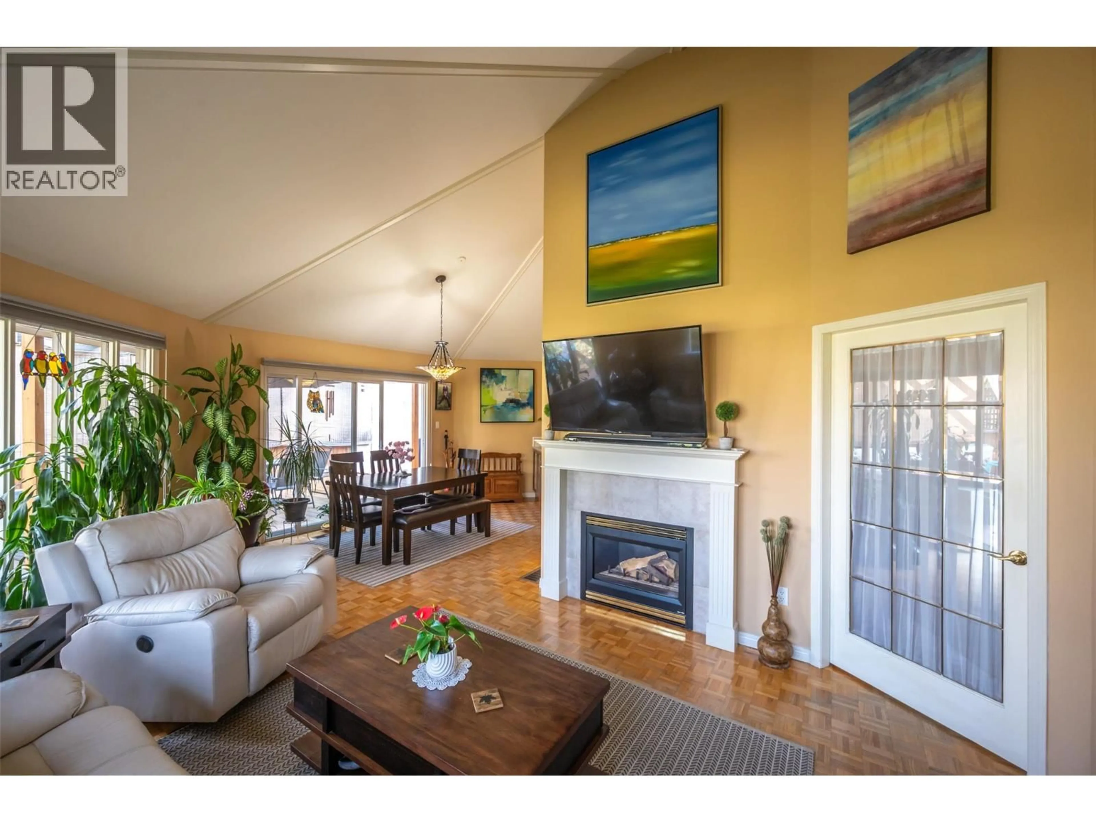Living room with furniture, wood/laminate floor for 4744 LAKESIDE ROAD, Penticton British Columbia V2A8W6