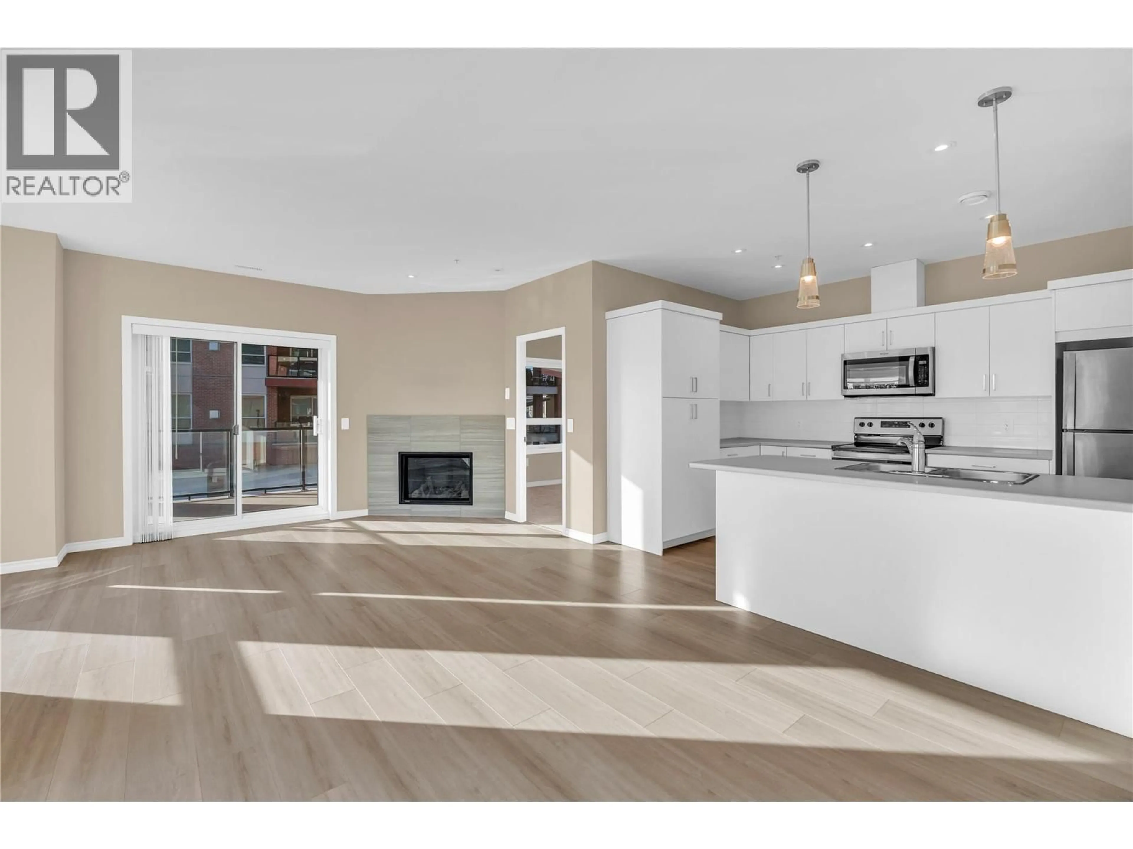 Open concept kitchen, wood/laminate floor for 203 - 3362 SKAHA LAKE ROAD, Penticton British Columbia V2A6G4