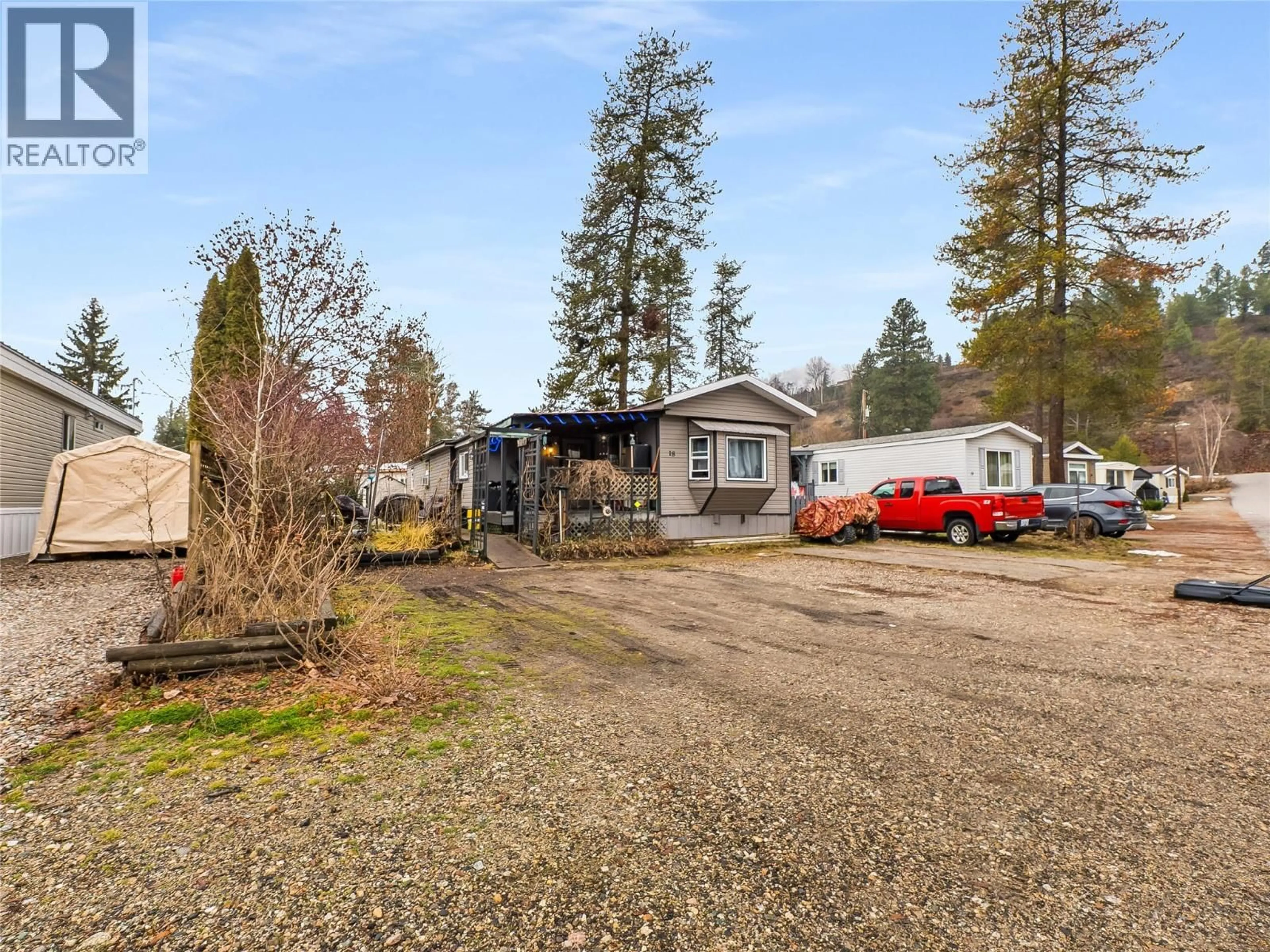 A pic from outside/outdoor area/front of a property/back of a property/a pic from drone, street for 18 - 500 16 AVENUE, Genelle British Columbia V0G1G0