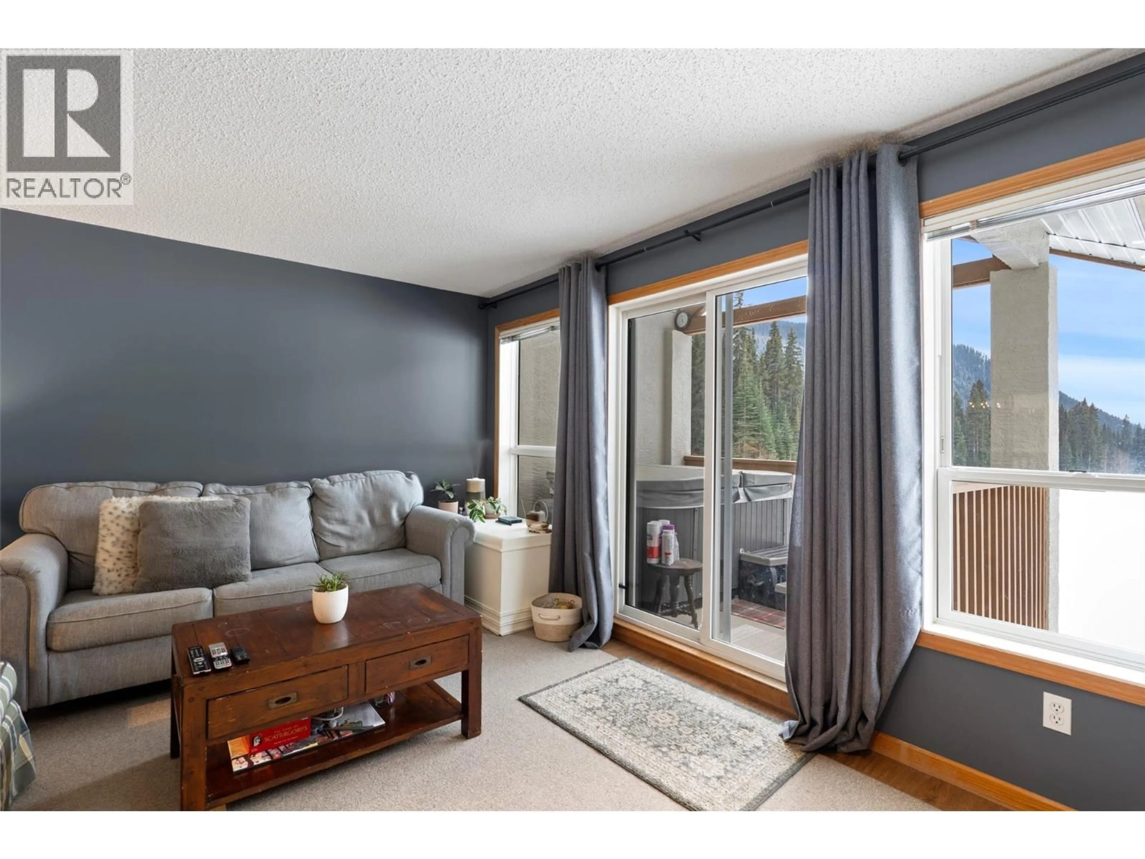 Living room with furniture, wood/laminate floor for 23 - 2120 SUN PEAKS ROAD, Sun Peaks British Columbia V0E5N0