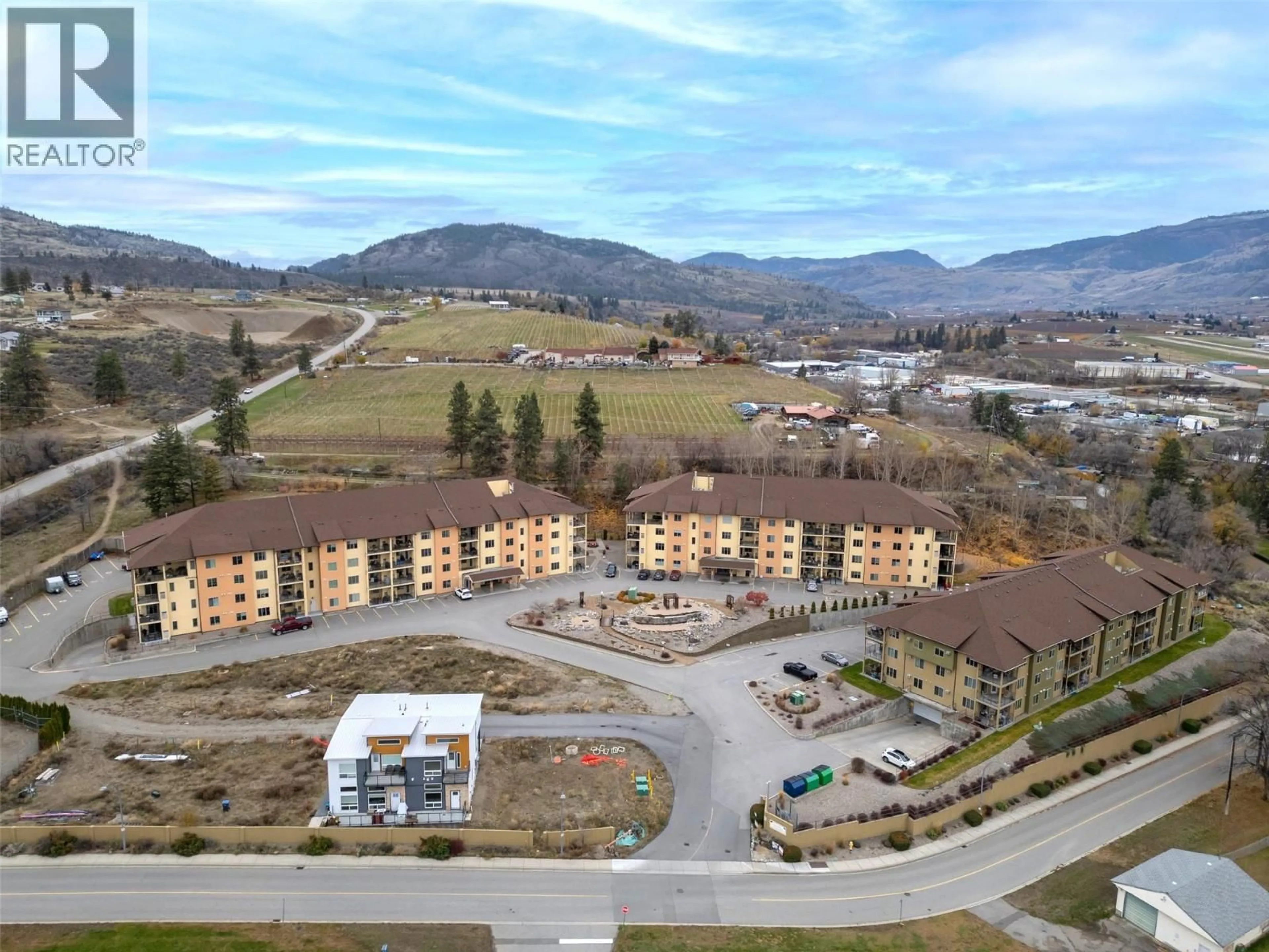 A pic from outside/outdoor area/front of a property/back of a property/a pic from drone, mountain view for 208A - 921 SPILLWAY ROAD, Oliver British Columbia V0H1T8