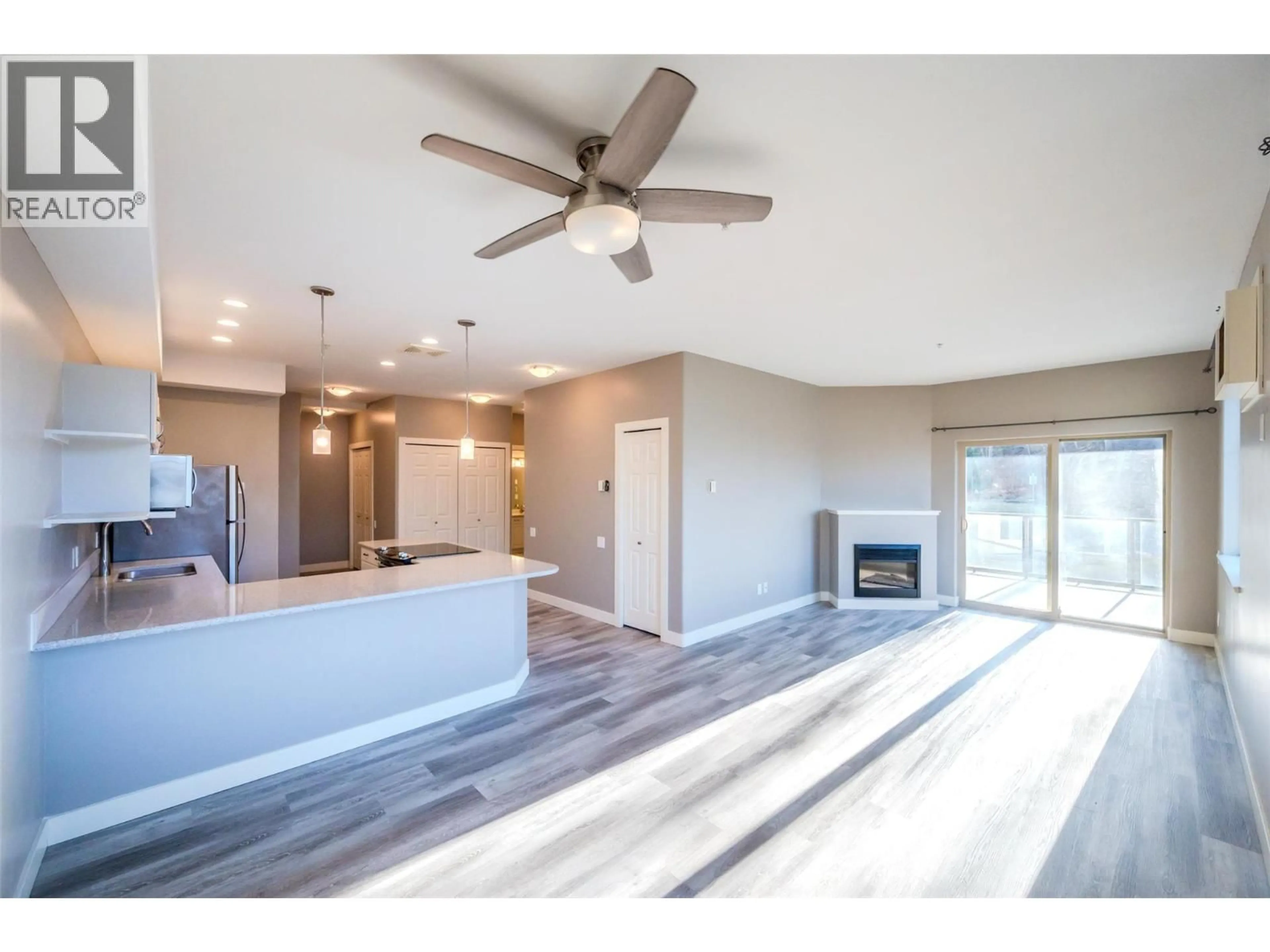 Open concept kitchen, wood/laminate floor for 208A - 921 SPILLWAY ROAD, Oliver British Columbia V0H1T8