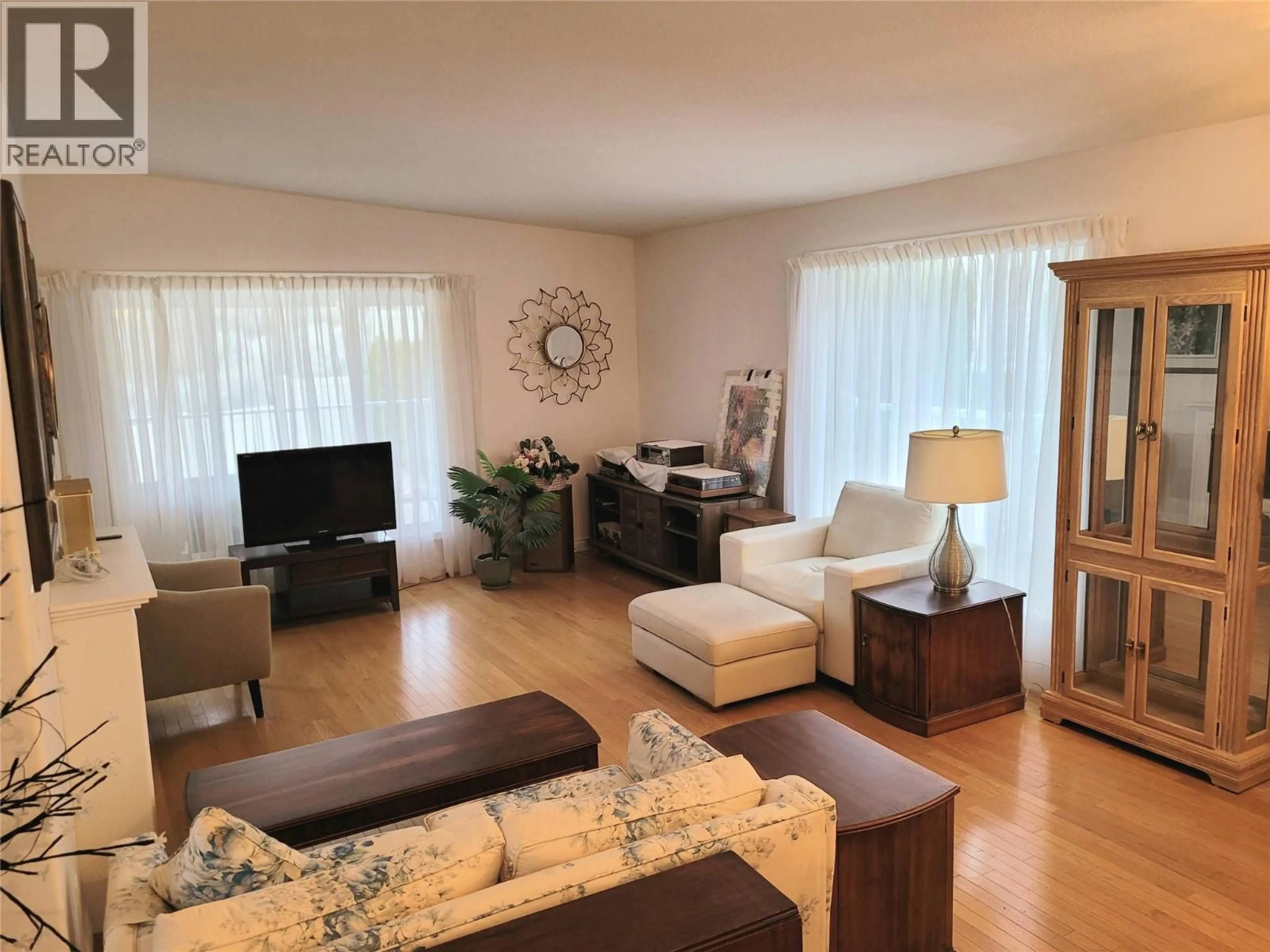 Living room with furniture, wood/laminate floor for 55 - 9400 115TH STREET, Osoyoos British Columbia V0H1V5