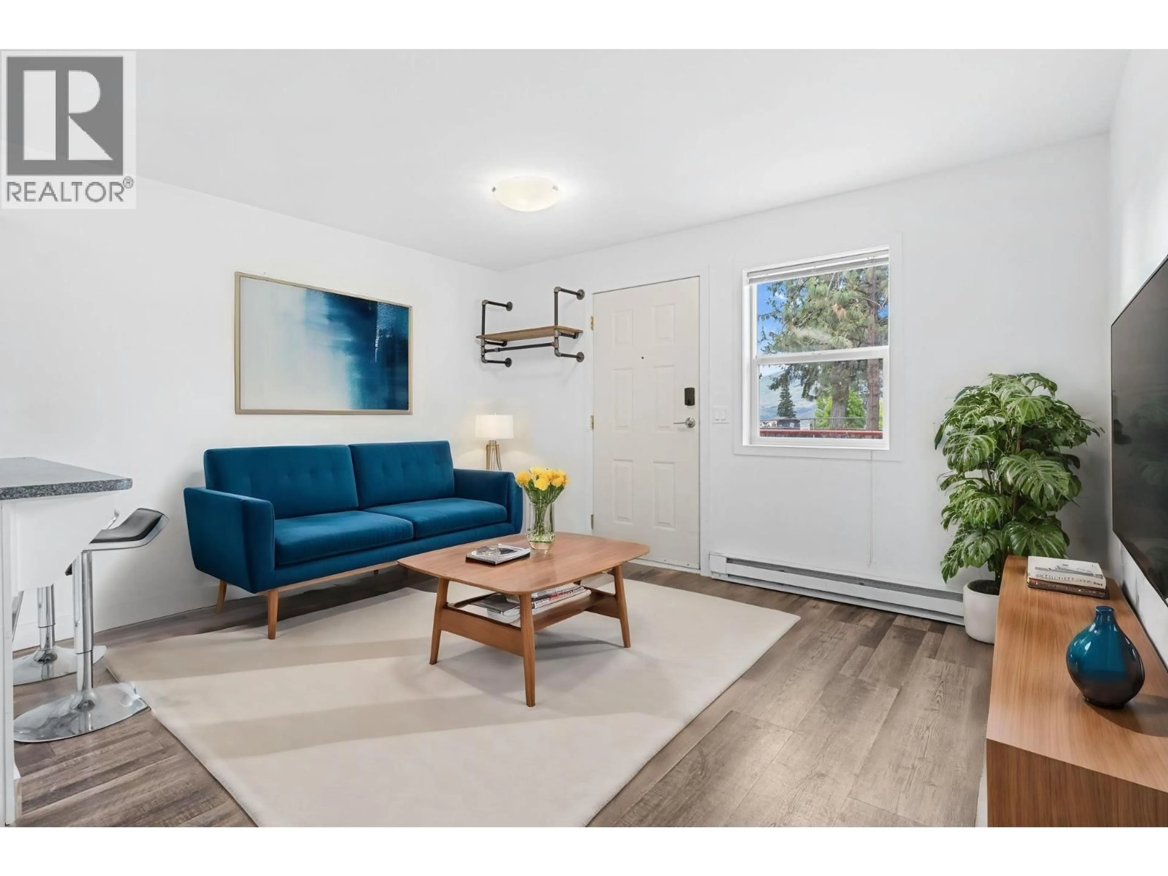 Living room with furniture, wood/laminate floor for 205 - 2585 HEBERT ROAD, West Kelowna British Columbia V4T2W4