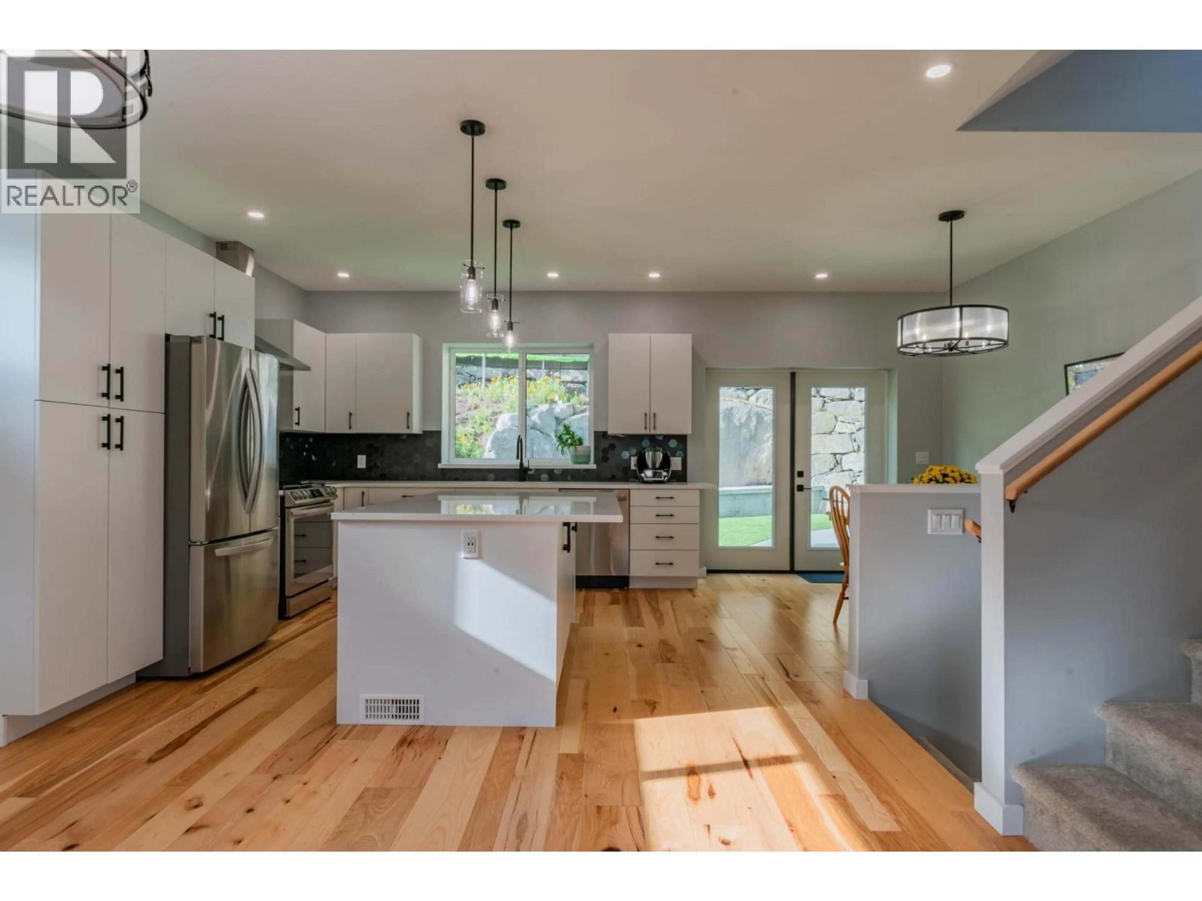 Open concept kitchen, wood/laminate floor for 934 REDSTONE DRIVE, Rossland British Columbia V0G1Y0