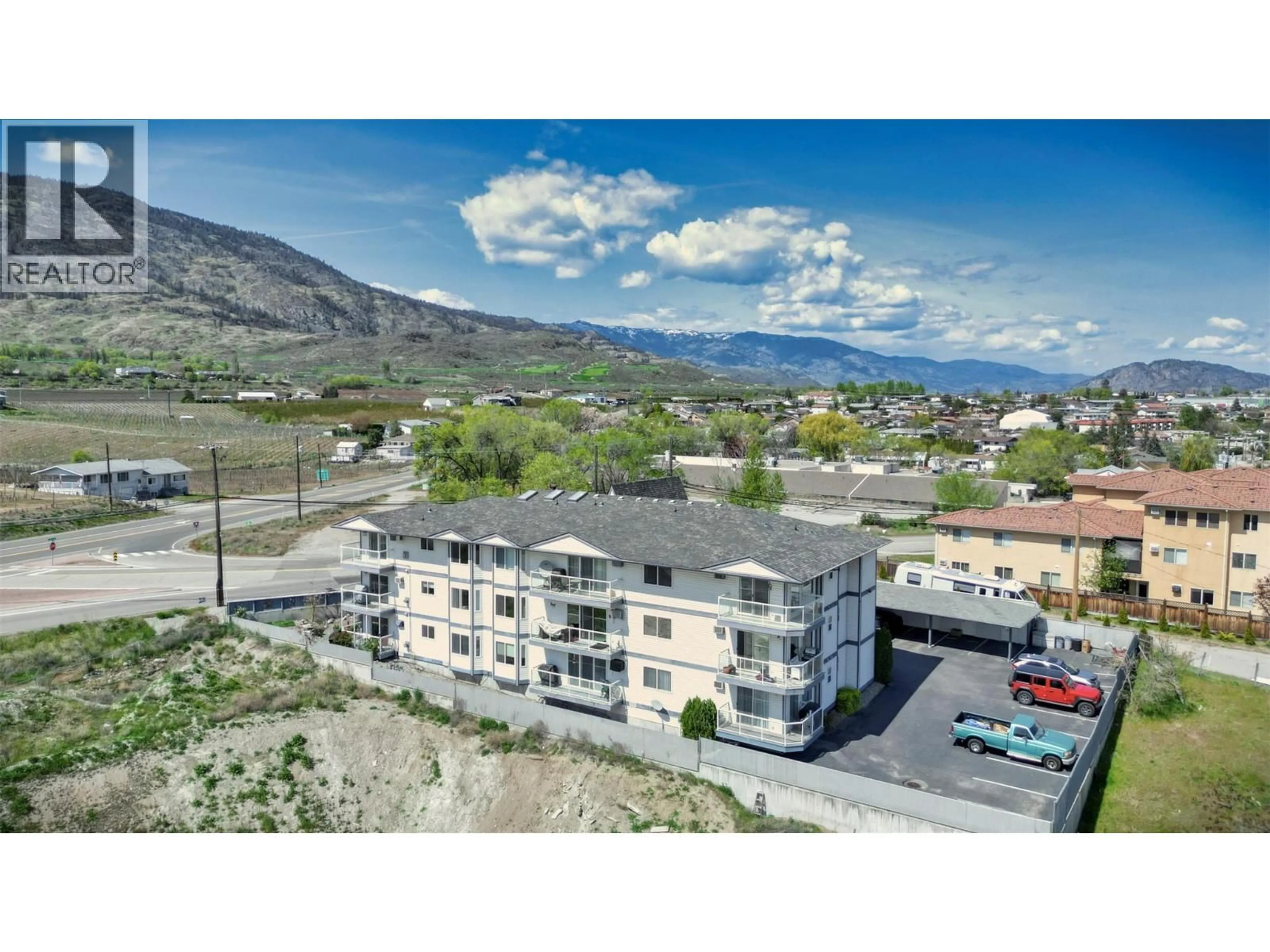 A pic from outside/outdoor area/front of a property/back of a property/a pic from drone, mountain view for 102 - 4801 89TH STREET, Osoyoos British Columbia V0H1V0