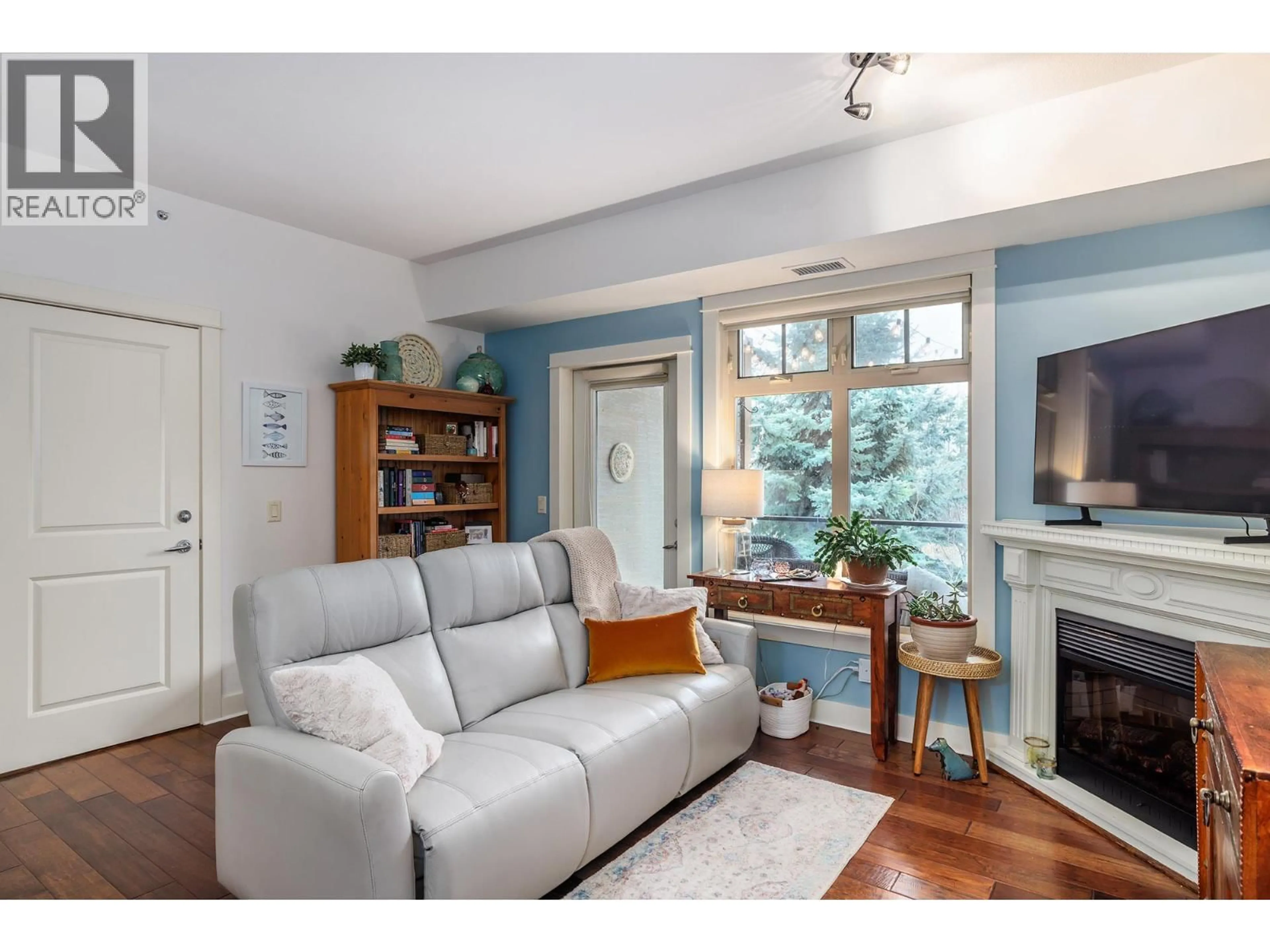 Living room with furniture, wood/laminate floor for 205 - 2611 STILLWATER WAY, Lake Country British Columbia V4V2R3