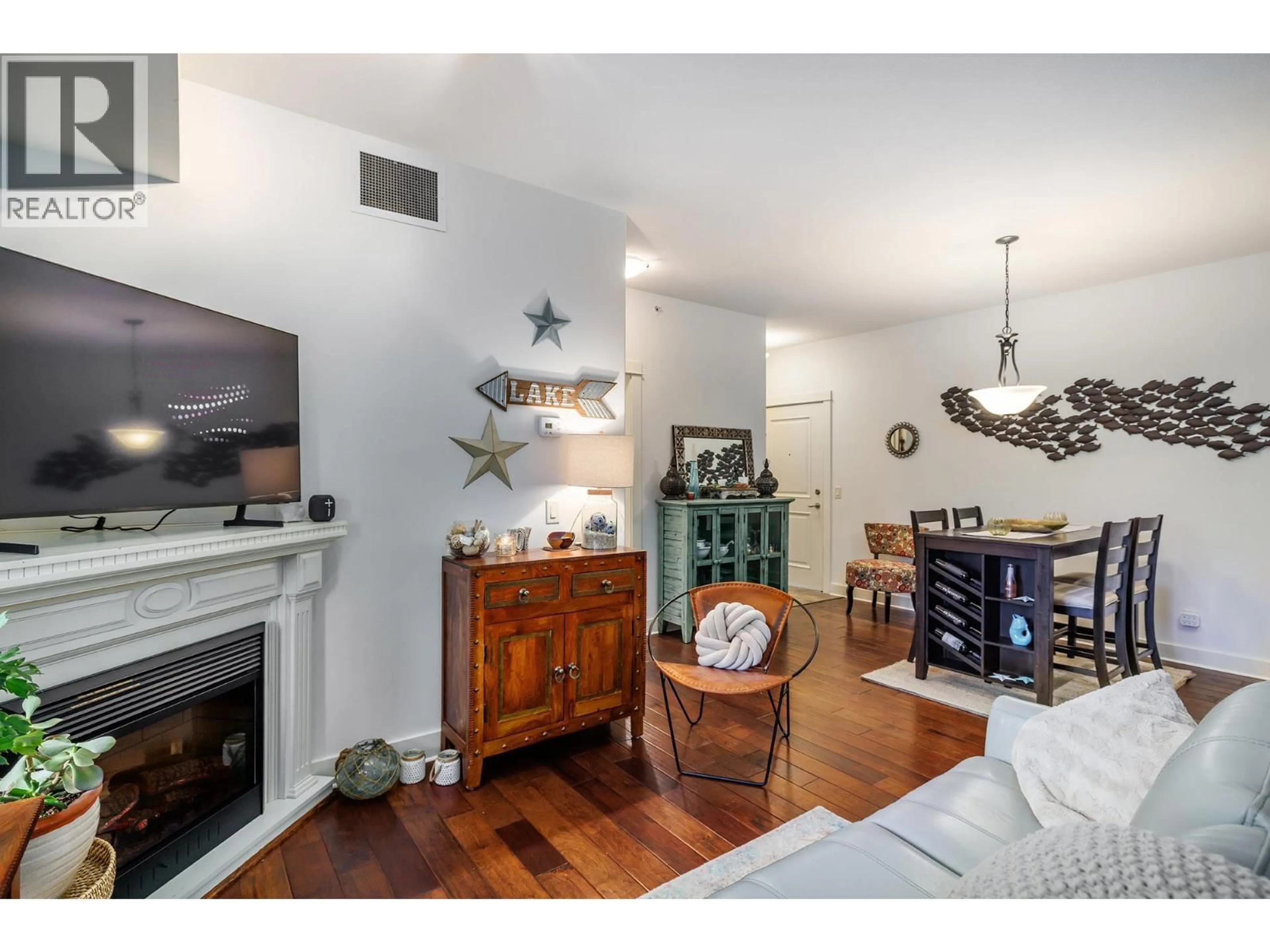 Living room with furniture, wood/laminate floor for 205 - 2611 STILLWATER WAY, Lake Country British Columbia V4V2R3