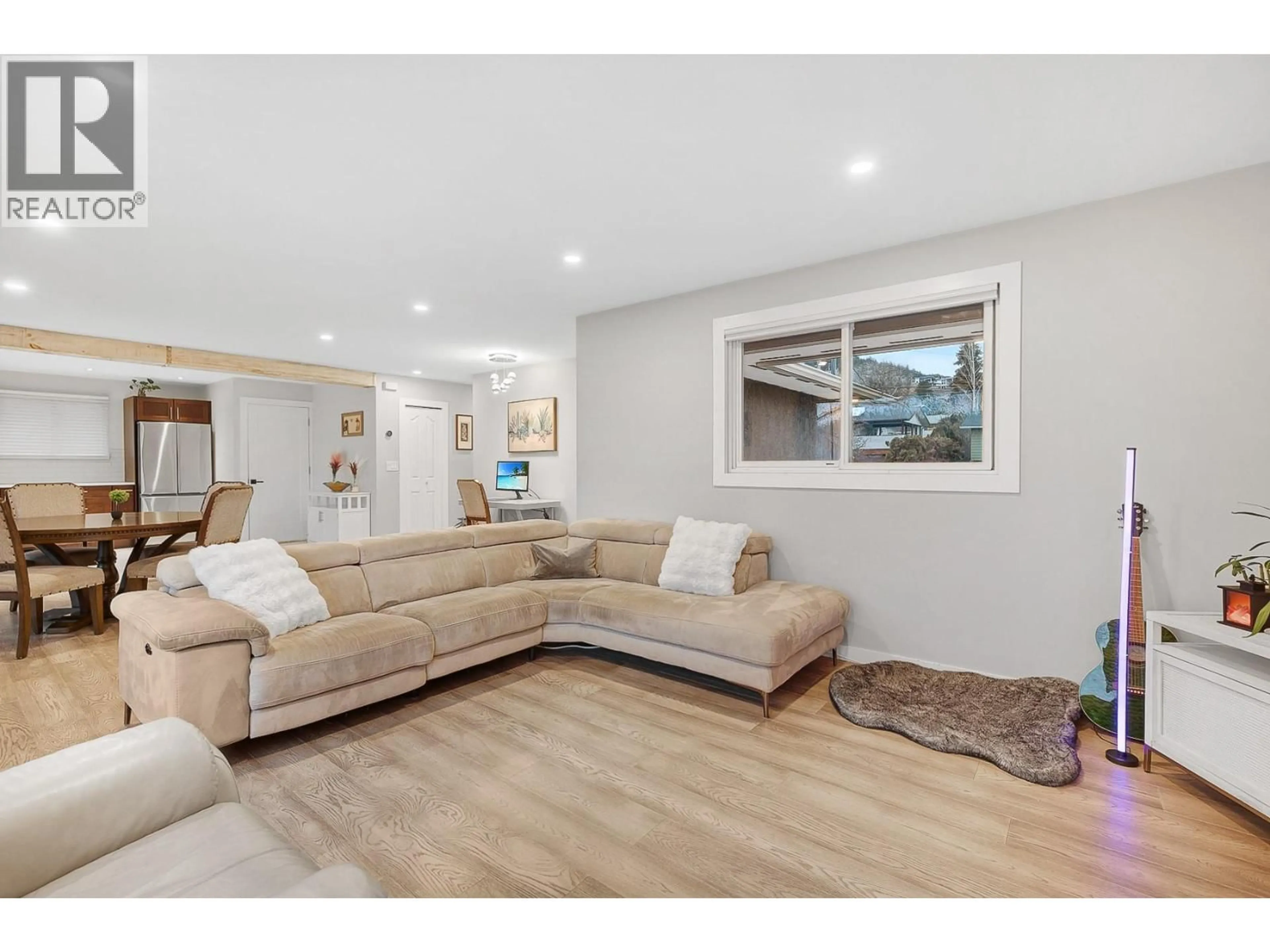 Living room with furniture, wood/laminate floor for 1785 CATHY COURT, Kelowna British Columbia V1P1L4