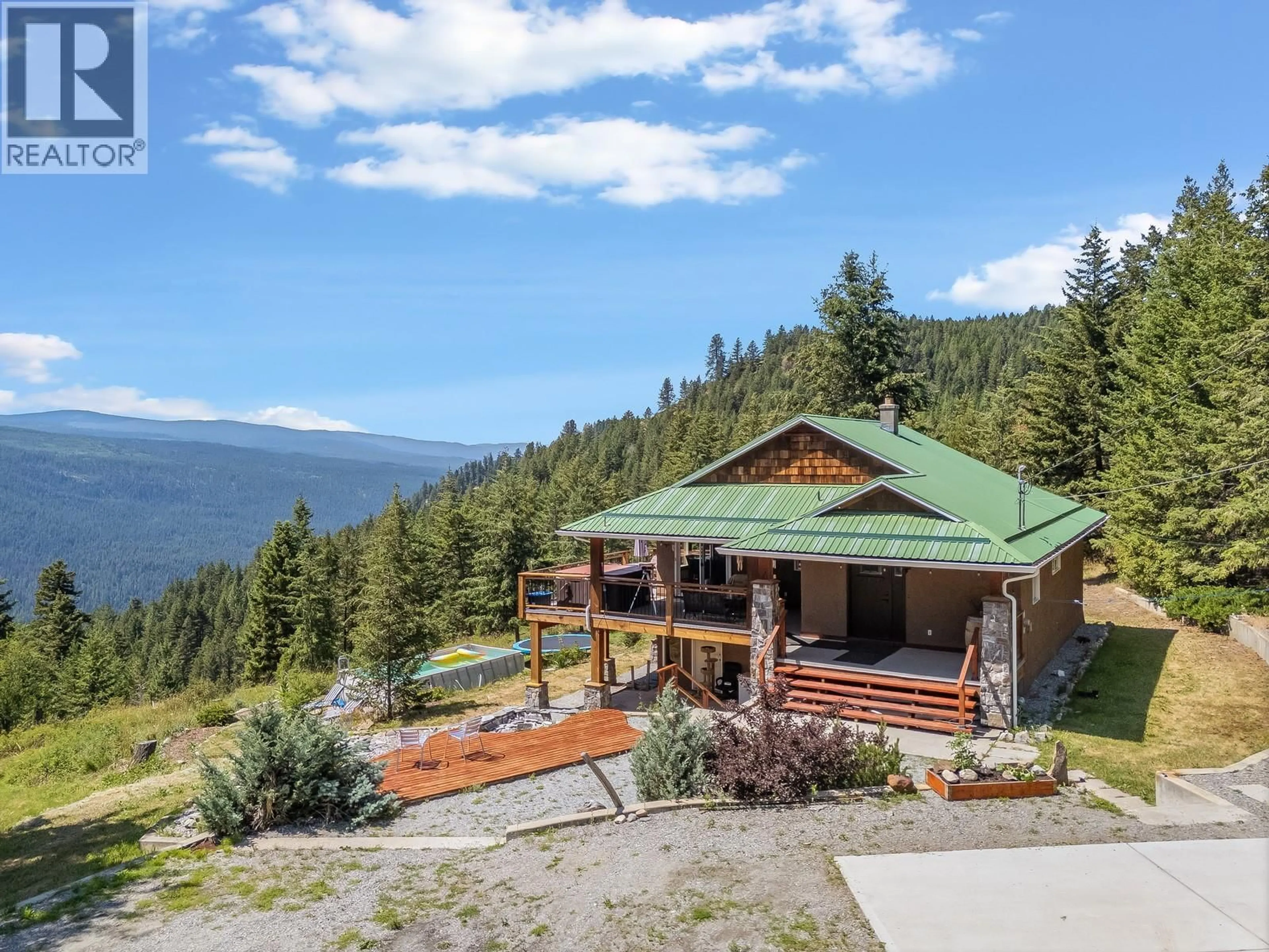 A pic from outside/outdoor area/front of a property/back of a property/a pic from drone, mountain view for 7575 SUN VALLEY ROAD, Kelowna British Columbia V1P1H4