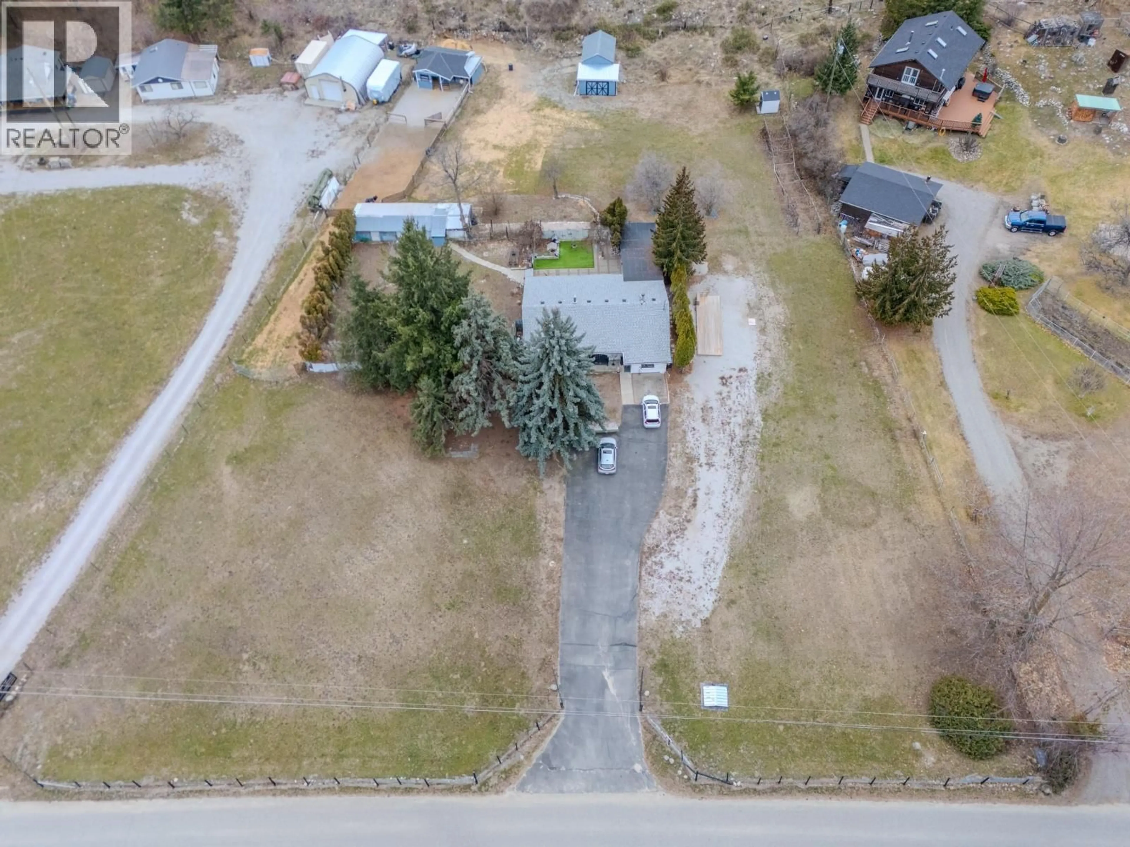 A pic from outside/outdoor area/front of a property/back of a property/a pic from drone, street for 5186 MACKINNON ROAD, Peachland British Columbia V0H1X2