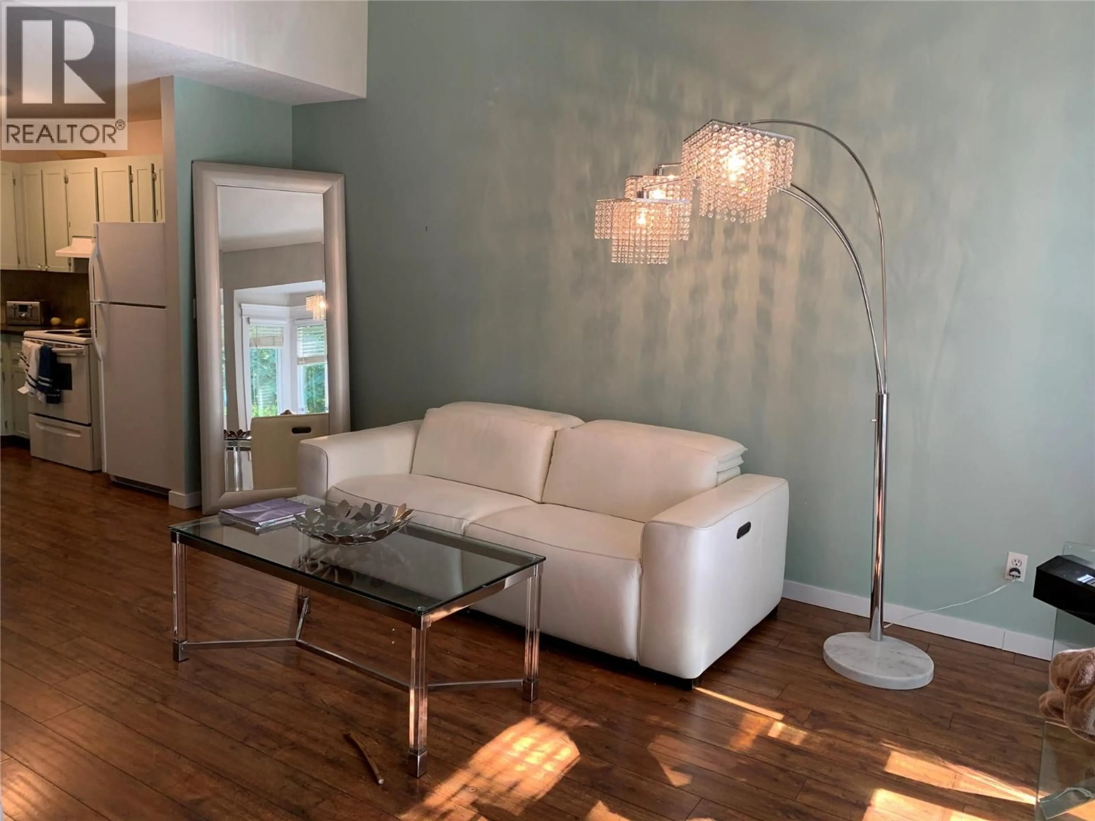 Living room with furniture, wood/laminate floor for 407 - 3155 GORDON DRIVE, Kelowna British Columbia V1W3N6