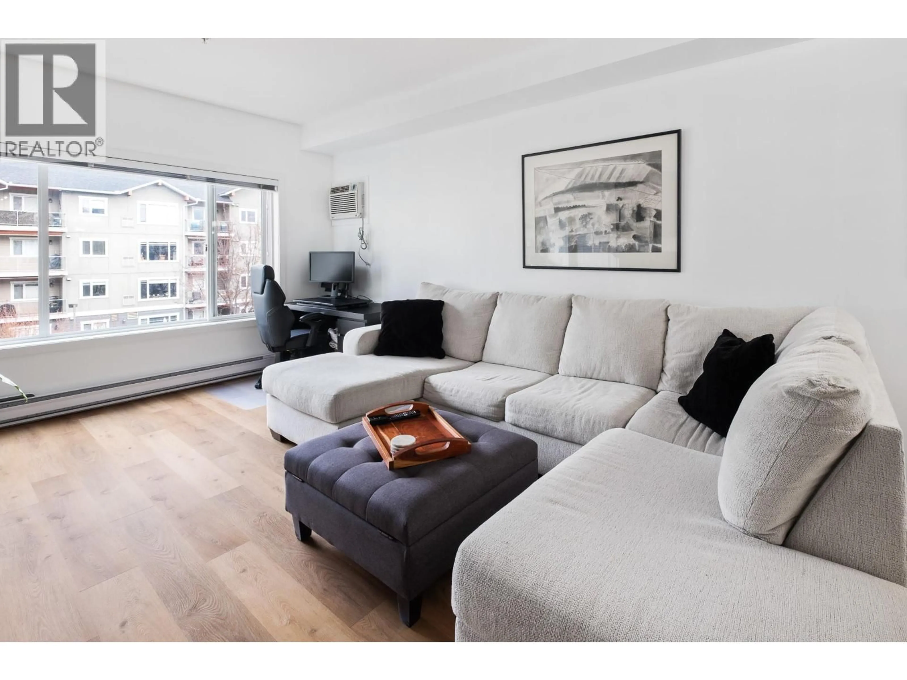 Living room with furniture, wood/laminate floor for 311 - 680 LEQUIME ROAD, Kelowna British Columbia V1W1A4