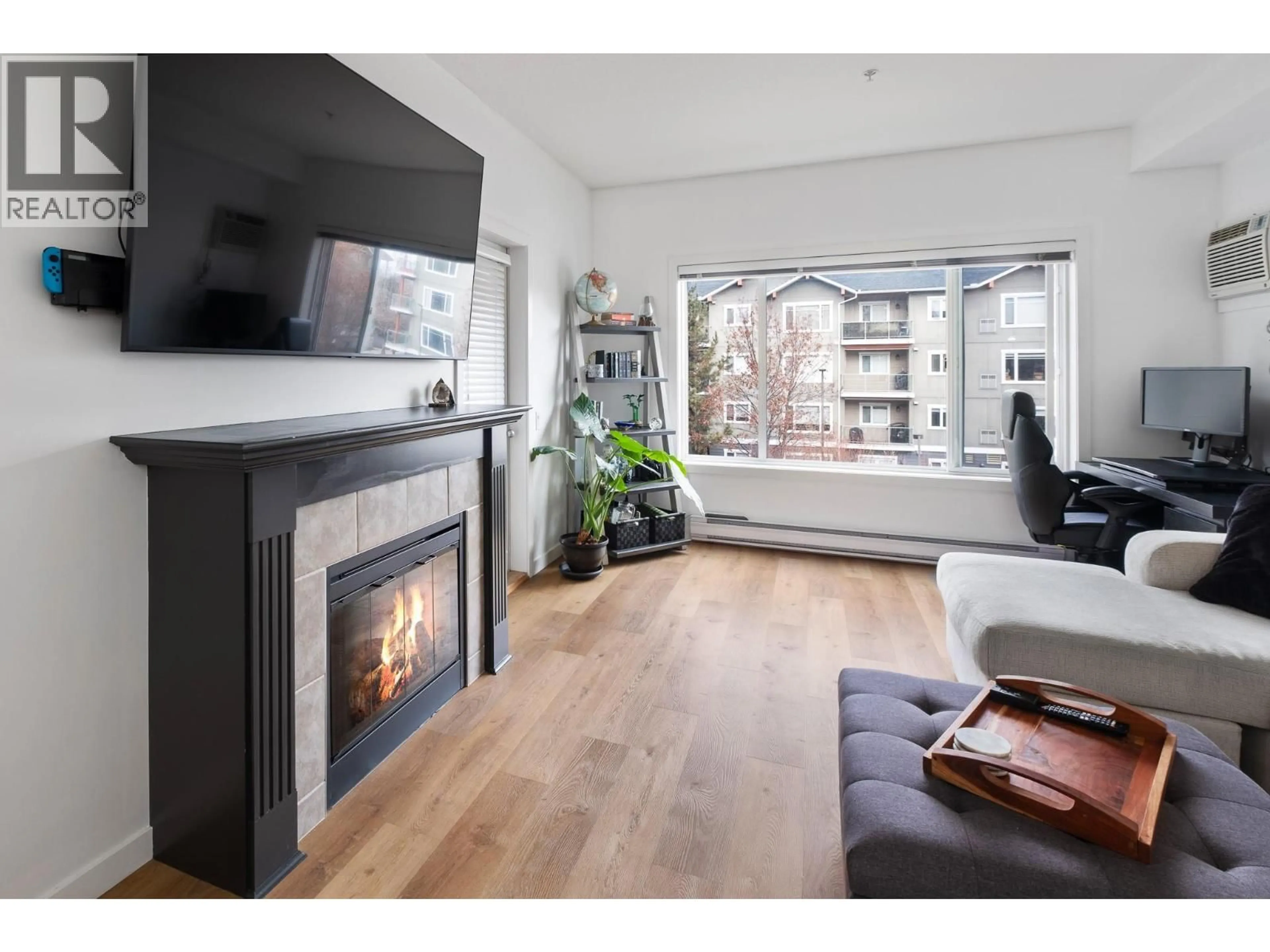 Living room with furniture, wood/laminate floor for 311 - 680 LEQUIME ROAD, Kelowna British Columbia V1W1A4