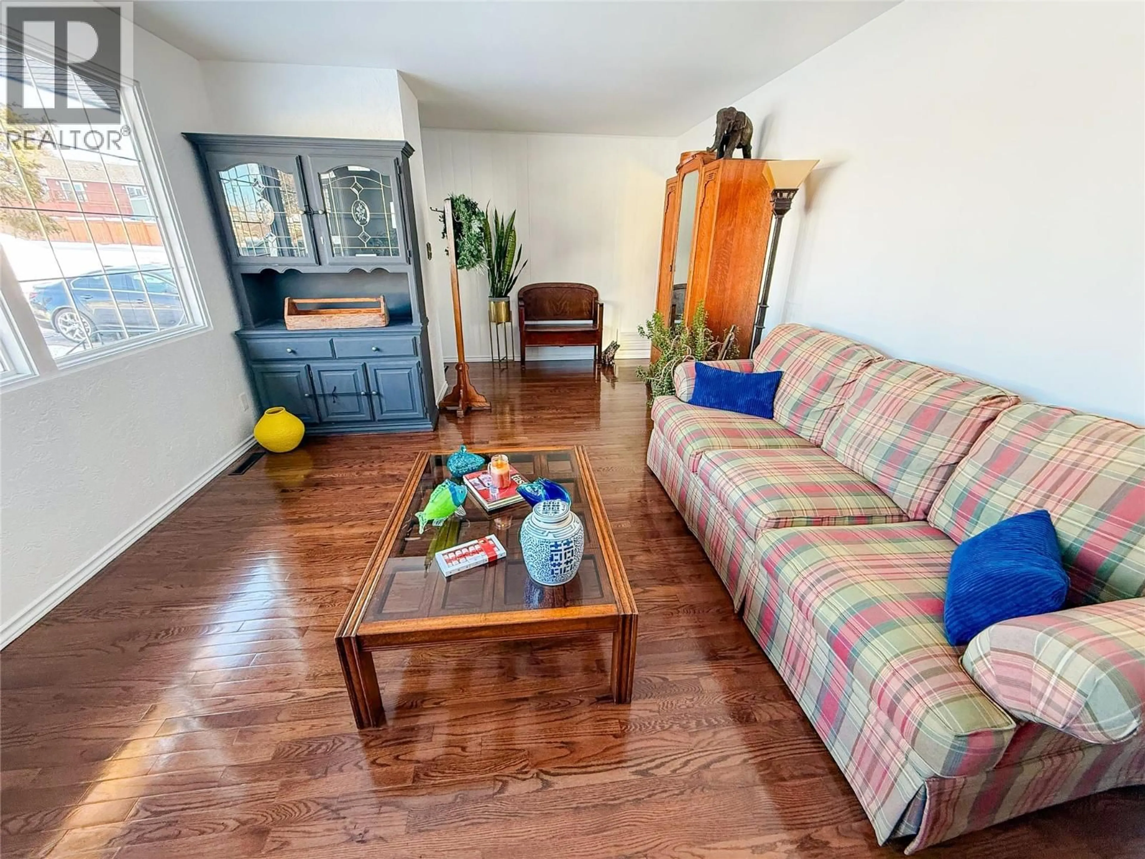 Living room with furniture, wood/laminate floor for 1905 90 AVENUE, Dawson Creek British Columbia V1G1A1