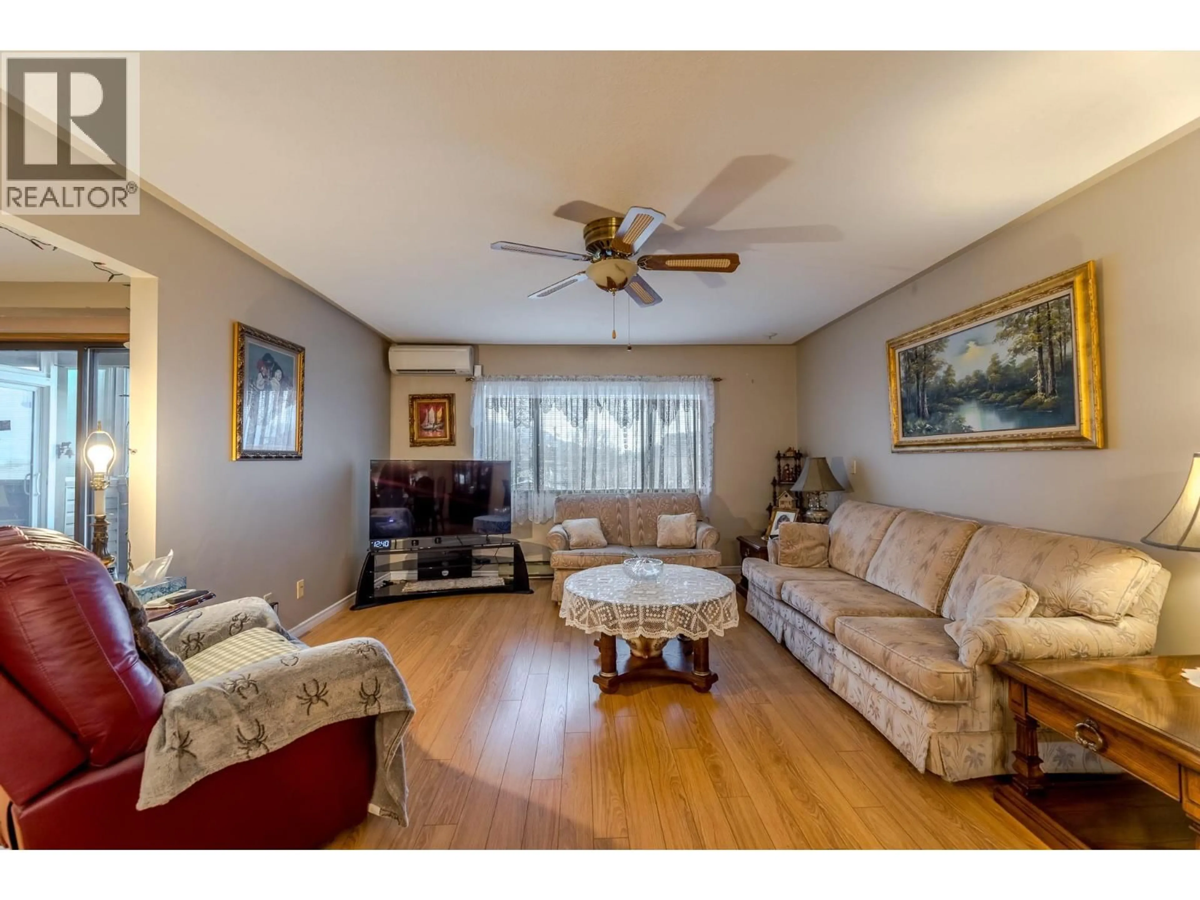 Living room with furniture, wood/laminate floor for 307 - 1820 ATKINSON STREET, Penticton British Columbia V2A7M6