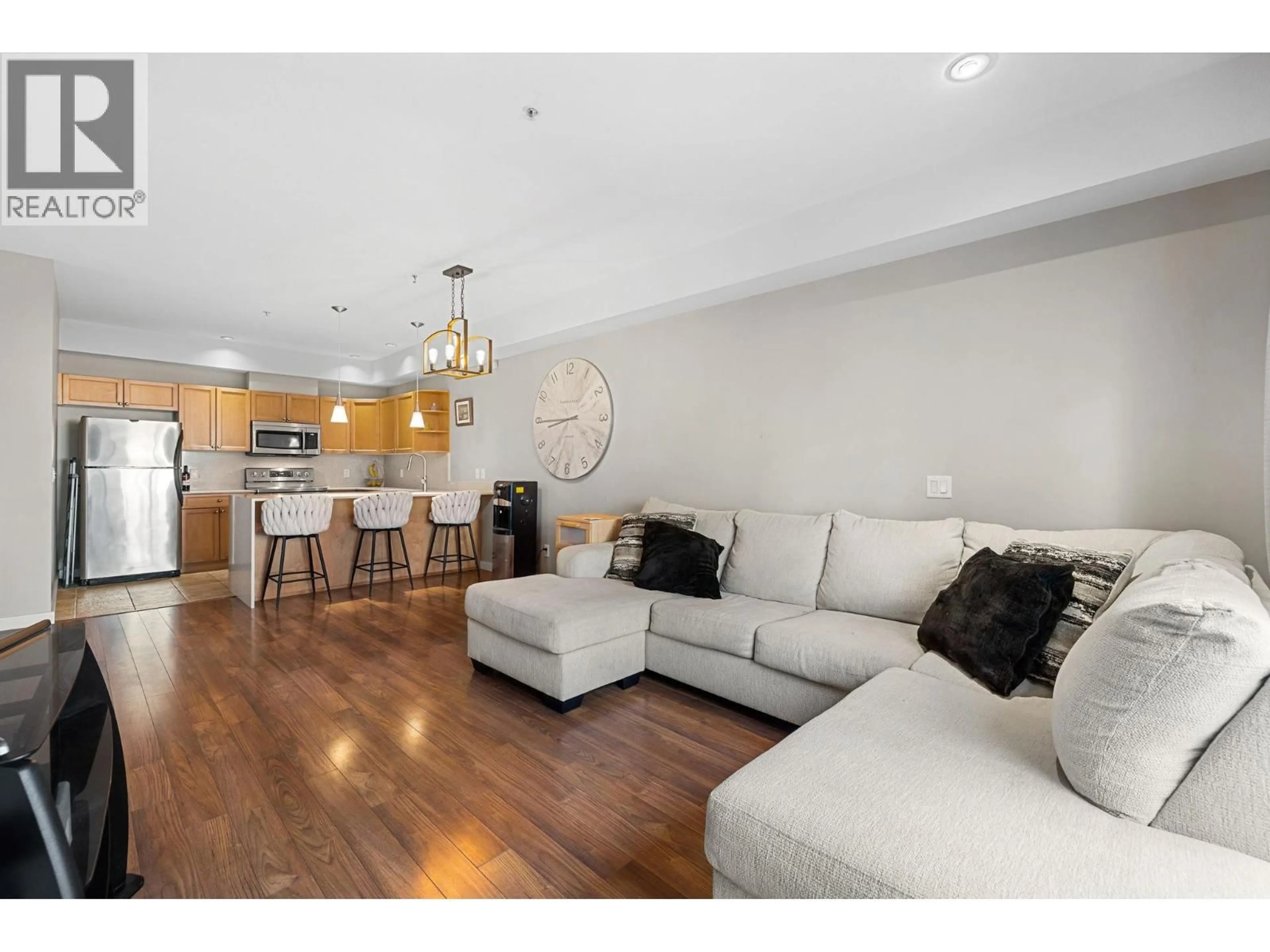 Living room with furniture, wood/laminate floor for 105 - 2120 SHANNON RIDGE DRIVE, West Kelowna British Columbia V4T2Z3