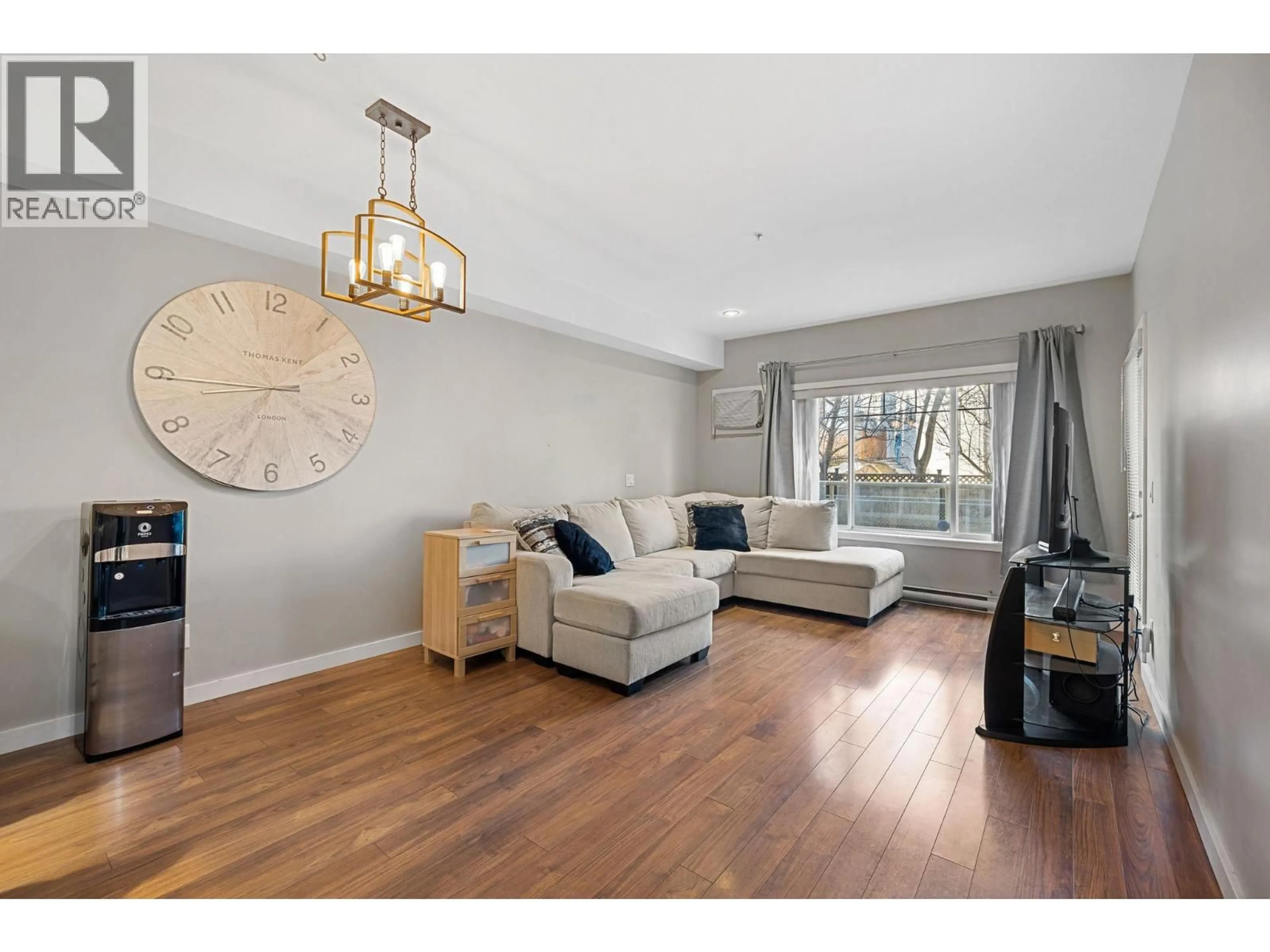 Living room with furniture, wood/laminate floor for 105 - 2120 SHANNON RIDGE DRIVE, West Kelowna British Columbia V4T2Z3